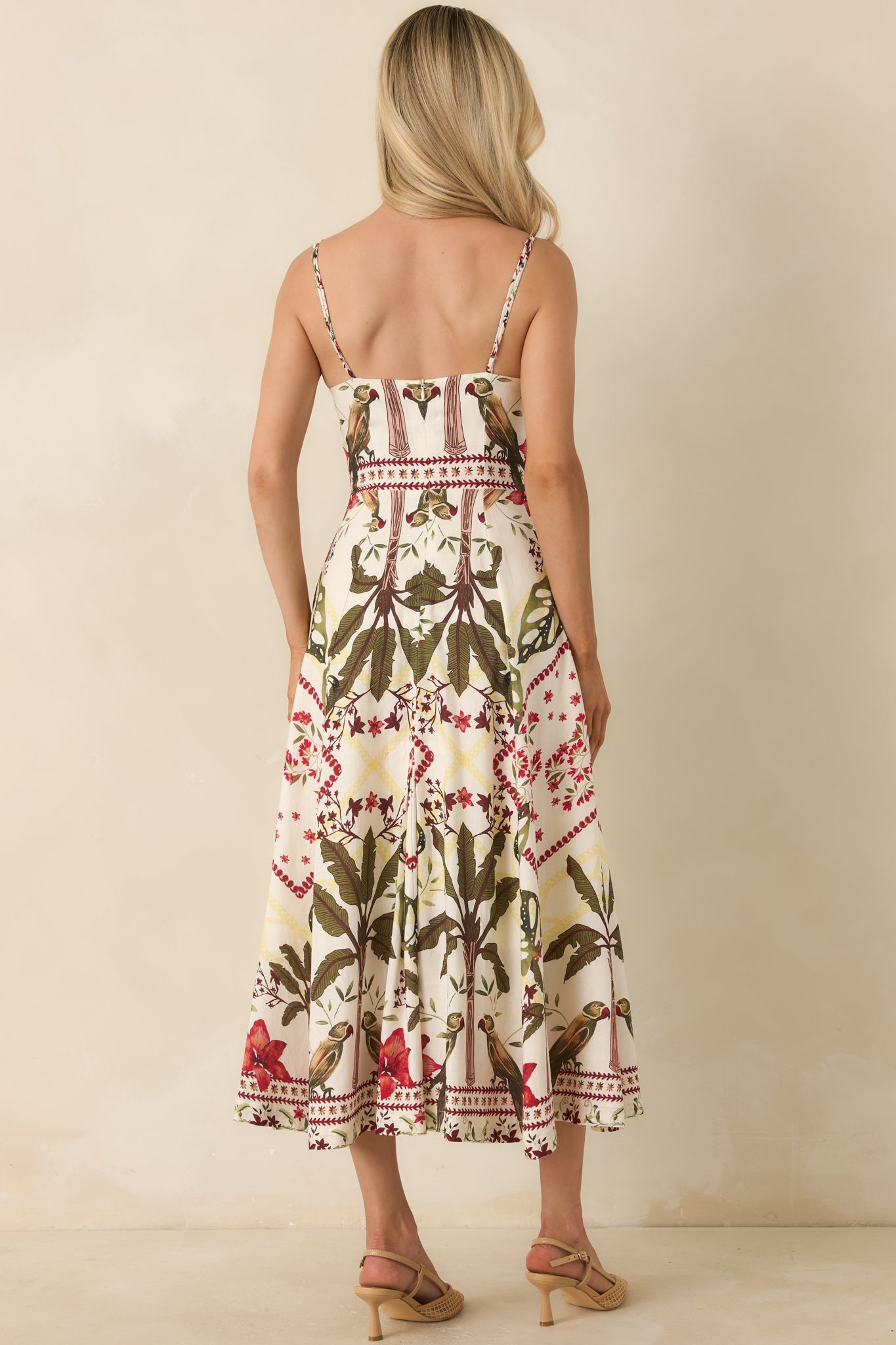 Rear view of the deep red and moss green tropical print maxi dress featuring a concealed back zipper closure and adjustable spaghetti straps.