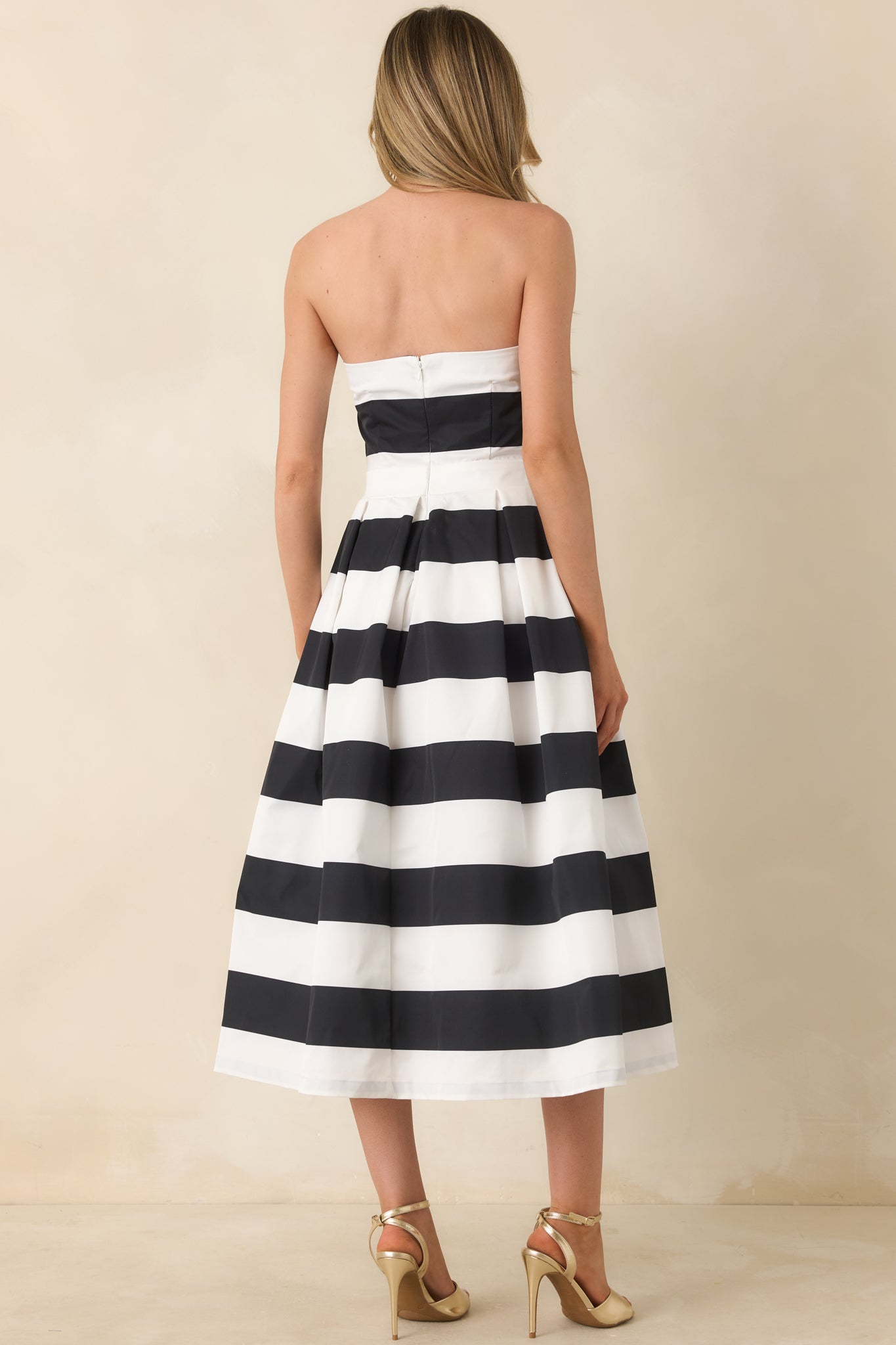 Back view of the dress highlighting the discrete zipper down the back, the thick waistband, and the continuation of the stripe pattern