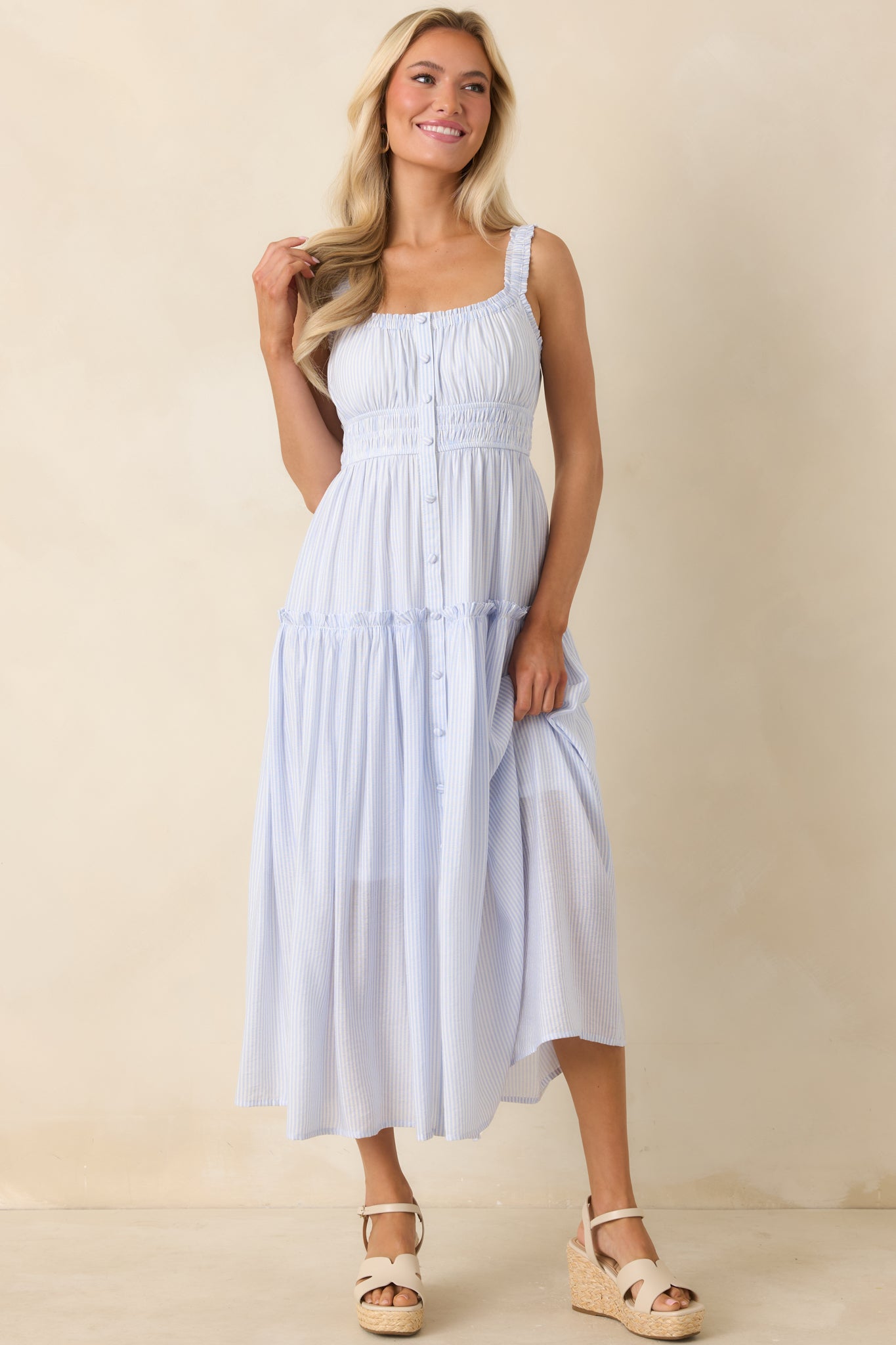 Tiered pinstripe dress with feminine ruffled straps, front buttons, and an easy, flowing shape.