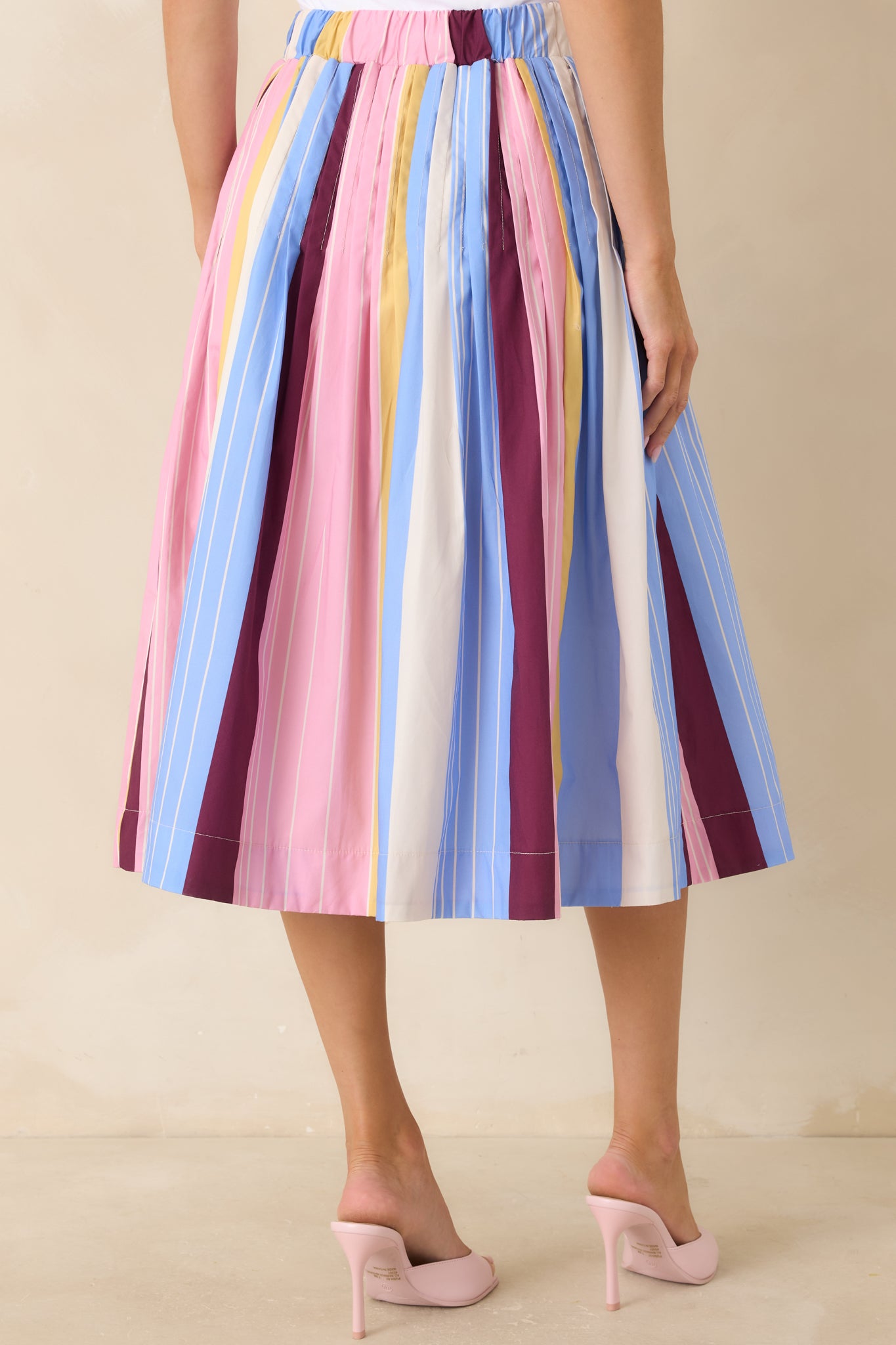 Rear view of striped midi skirt with high-rise fit and softly flared shape.