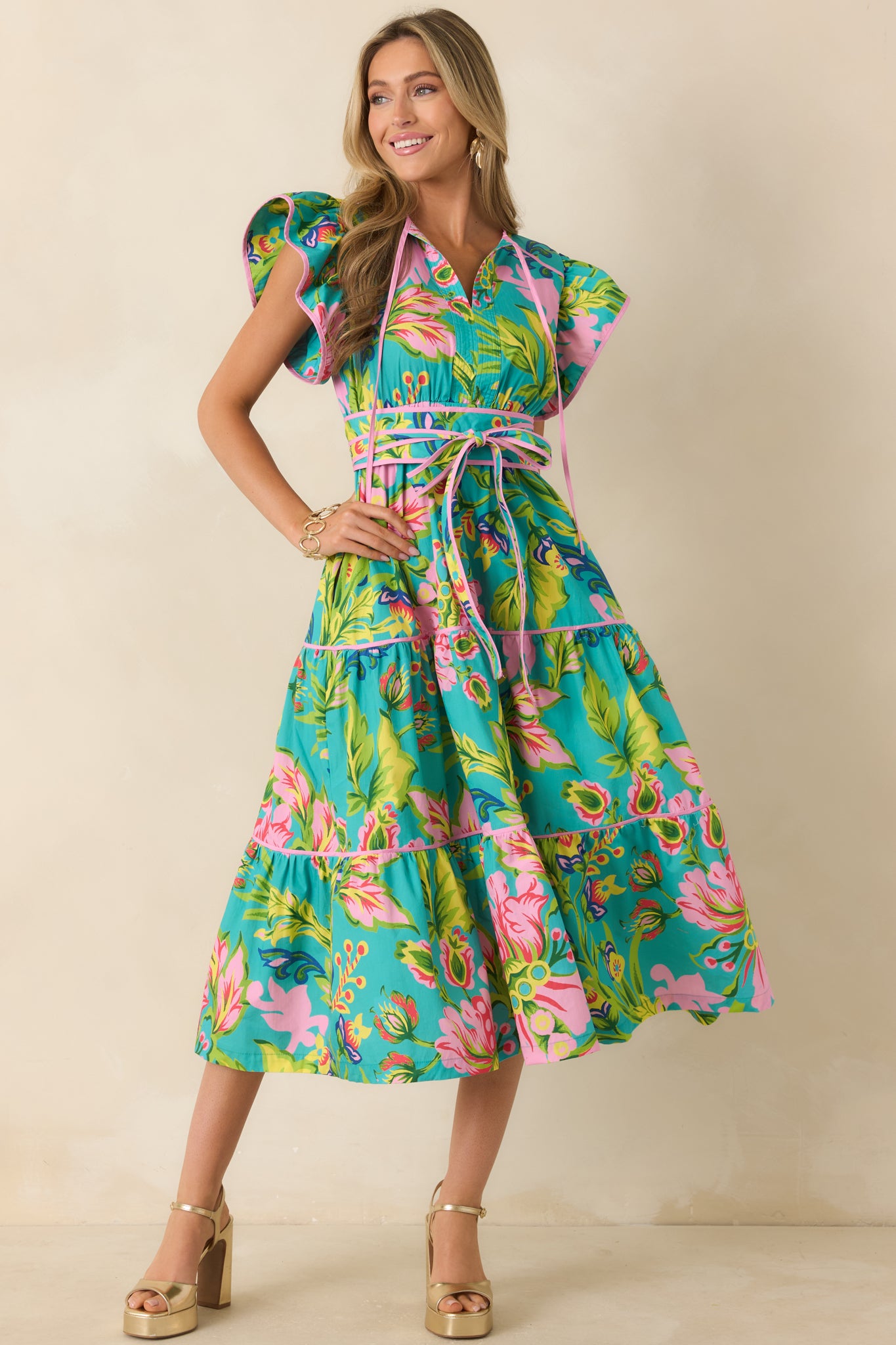 Jade tropical floral midi dress featuring a tiered skirt, flutter sleeves, and a flowy cotton silhouette.