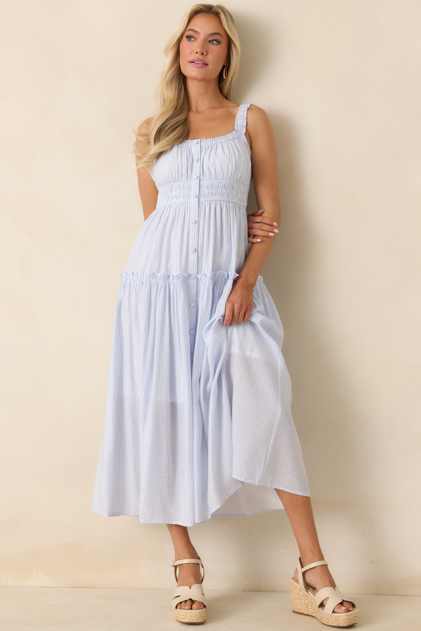 Pinstripe tiered dress with ruffled straps, smocked waist, and fabric-covered button front.