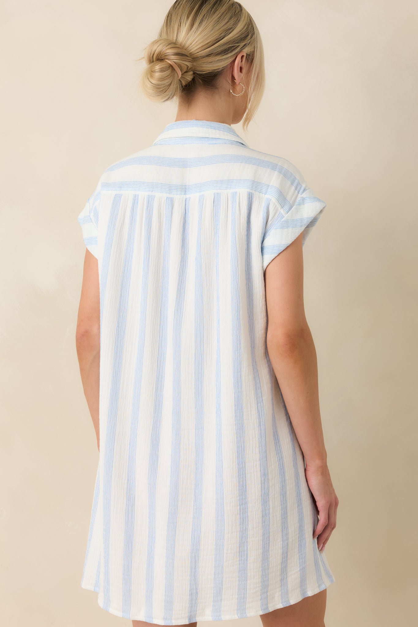 Rear view of the striped mini dress featuring a clean back silhouette with relaxed drape and continuous cotton gauze texture.