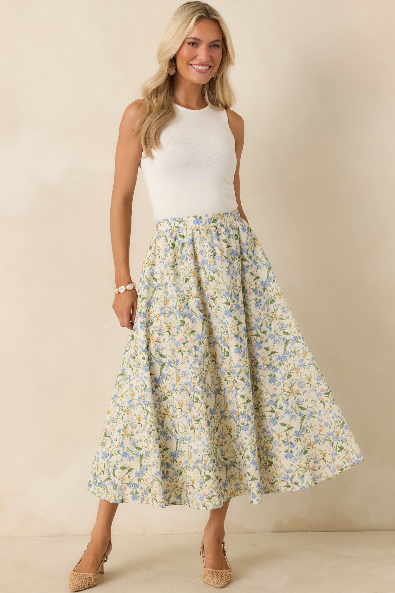 Cotton floral midi skirt showcasing a green, yellow, and blue print with a fully lined finish and an easy, graceful midi-length drape.