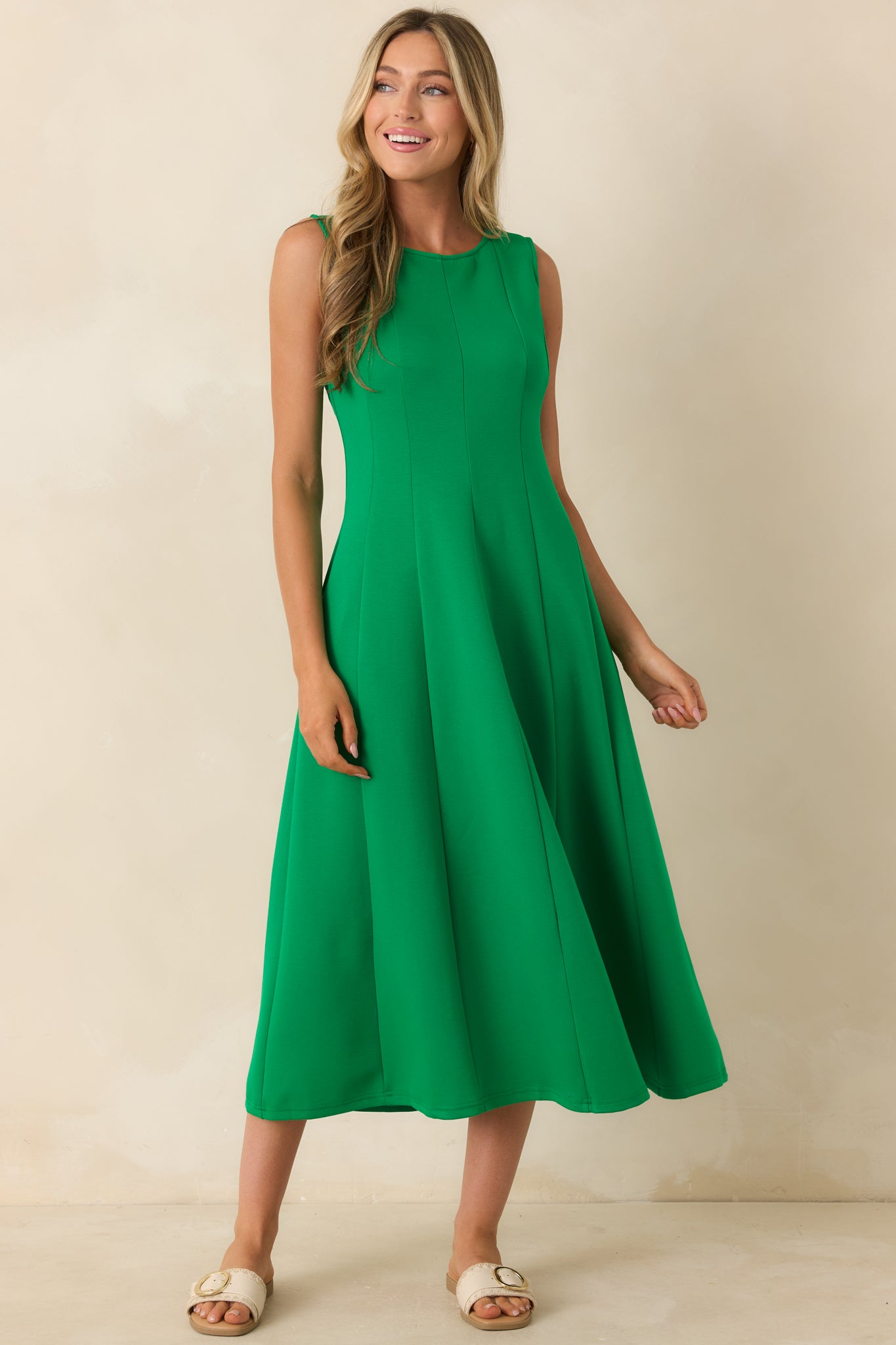 Green pull-on midi dress featuring flattering seam detailing, sleeveless styling, and a smooth, effortless drape.