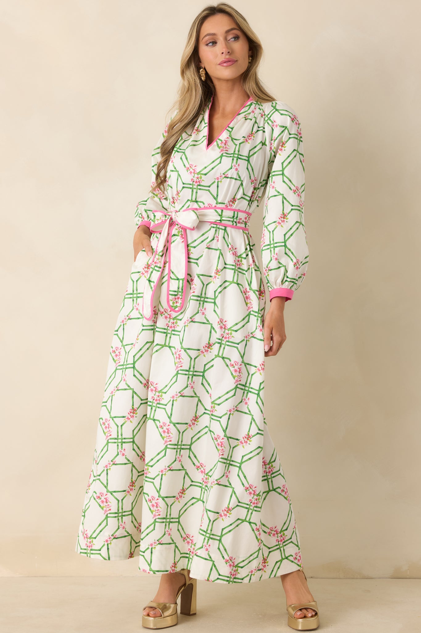 Floral trellis print dress showcasing an adjustable waist tie and relaxed, floor-length shape.