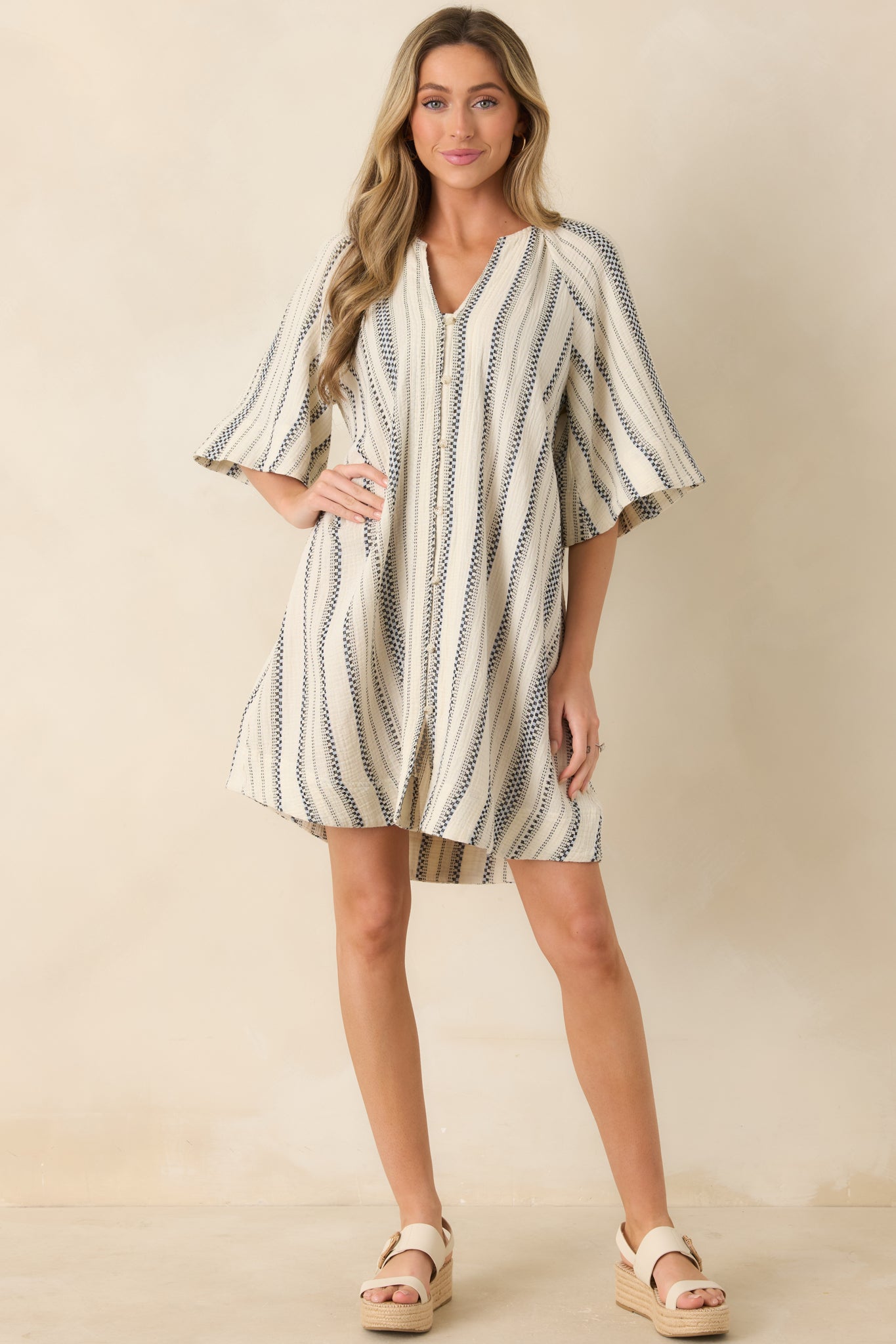 Striped mini dress with flowy elbow-length sleeves and easy warm-weather shape.