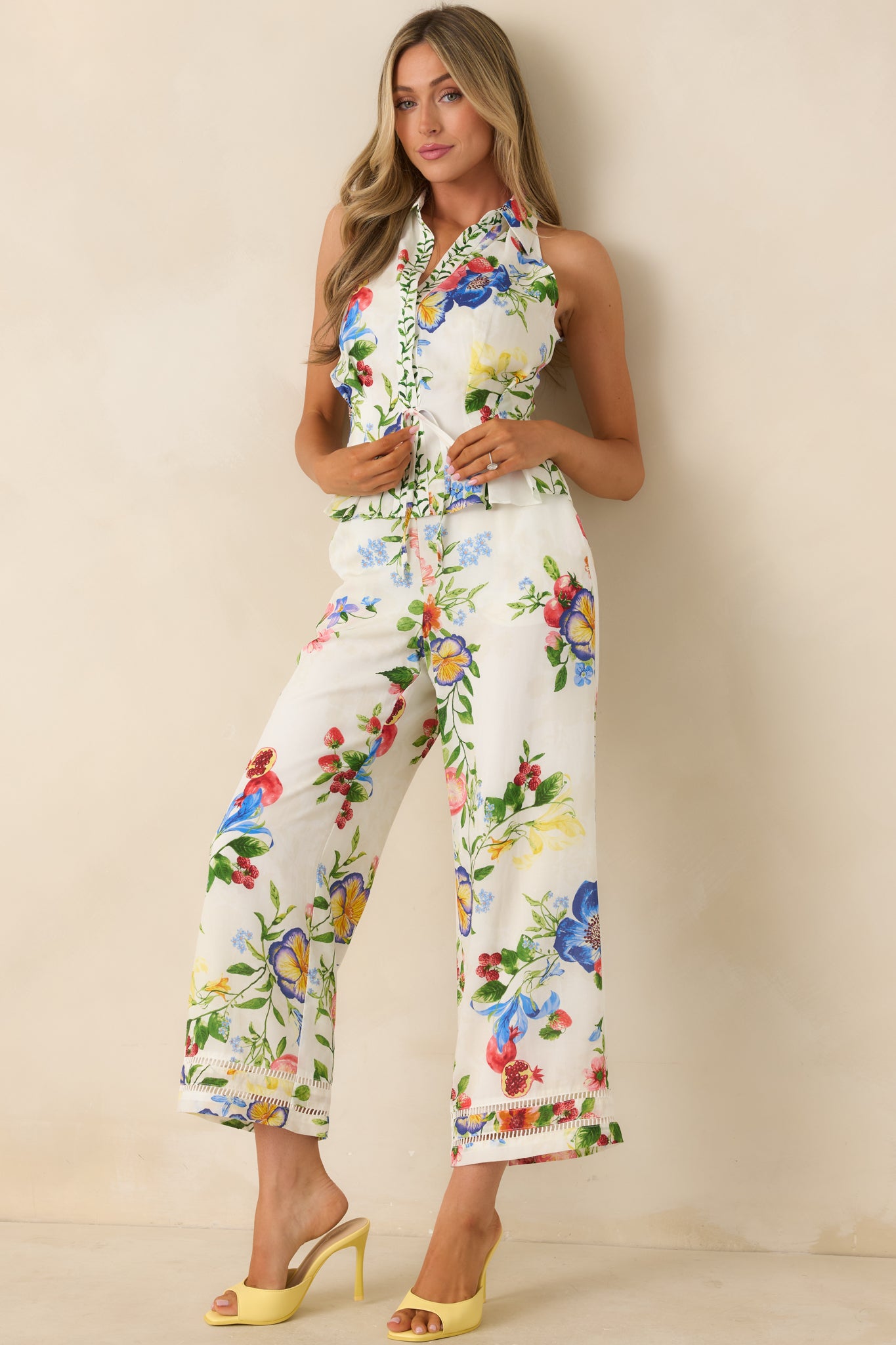 Ivory botanical print halter top featuring a tailored neckline, adjustable waist tie, and a lightweight, breathable lyocell-linen drape.