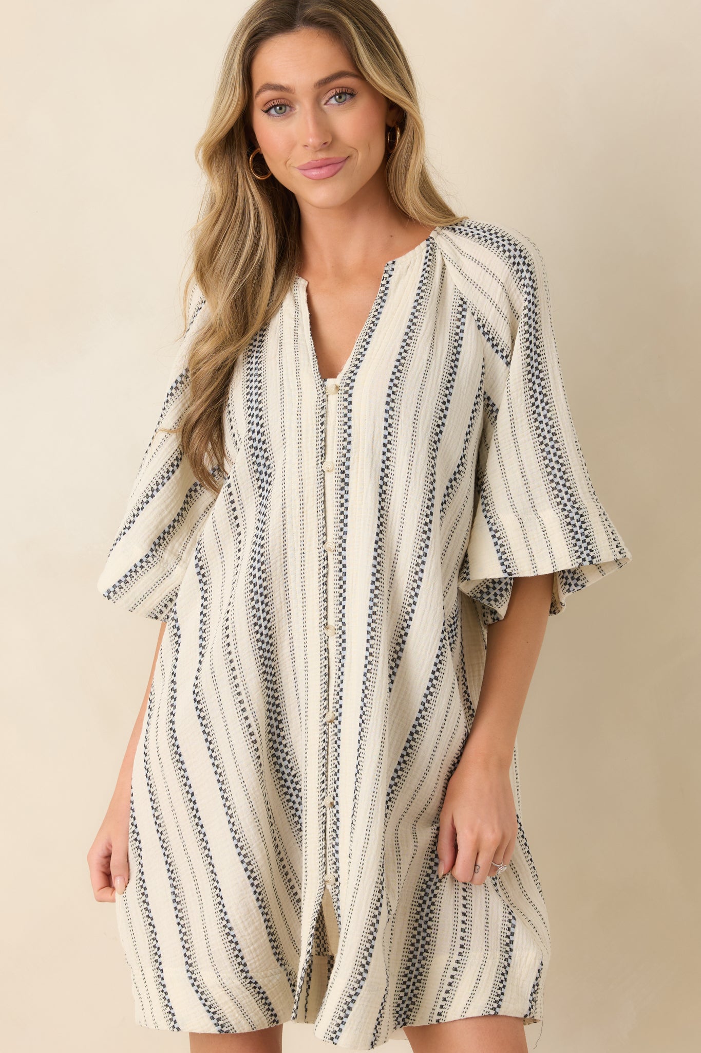 Relaxed oversized silhouette with airy drape and vertical stripe alignment.