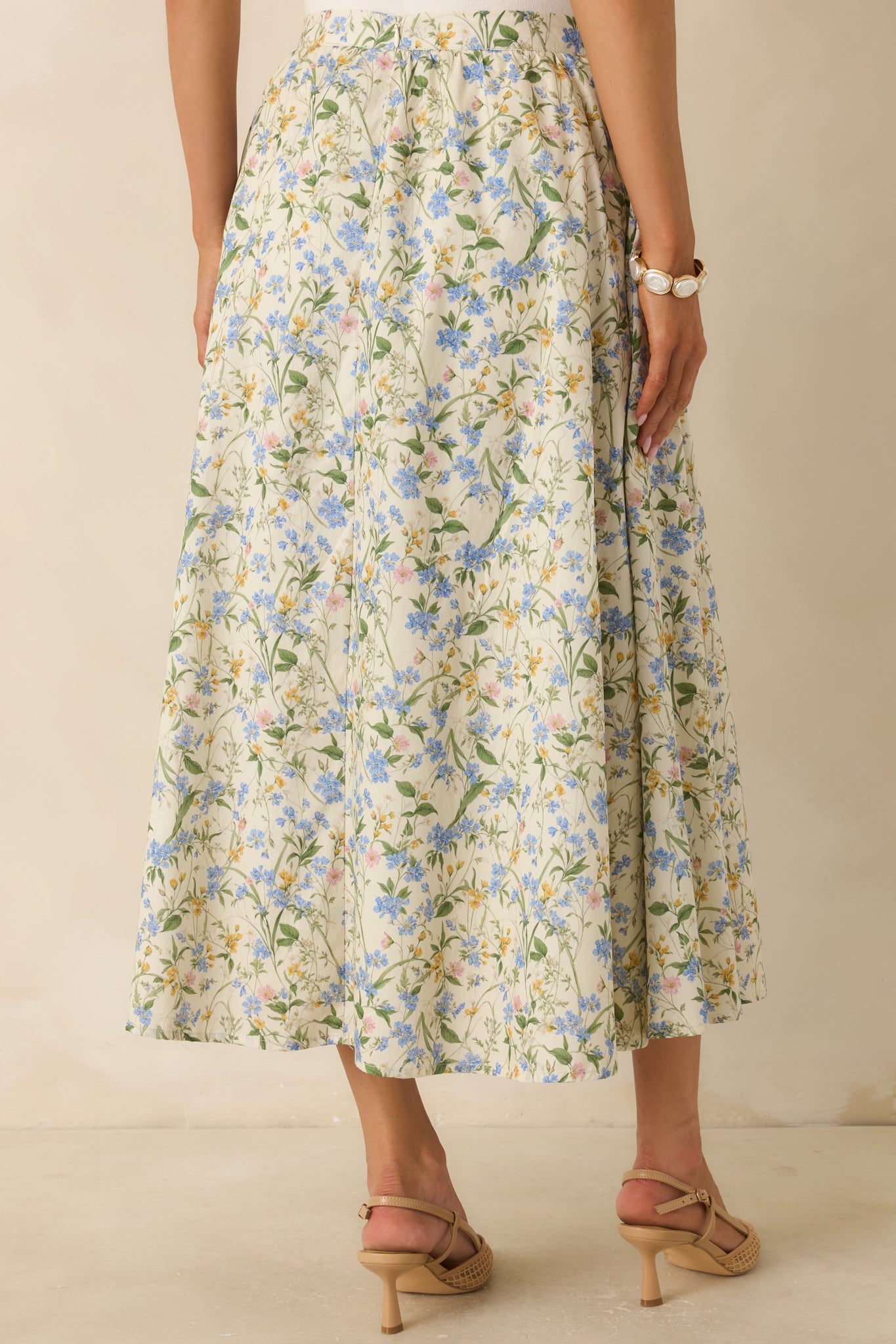 Rear view of the green floral midi skirt featuring an invisible back zipper with hook-and-eye closure and a gathered waistband.