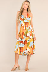 Front view of this dress that features a v-neckline, a self-tie feature at the back of the neck, an open back, a discrete back zipper, a twisted bust detail, and a colorful pattern.