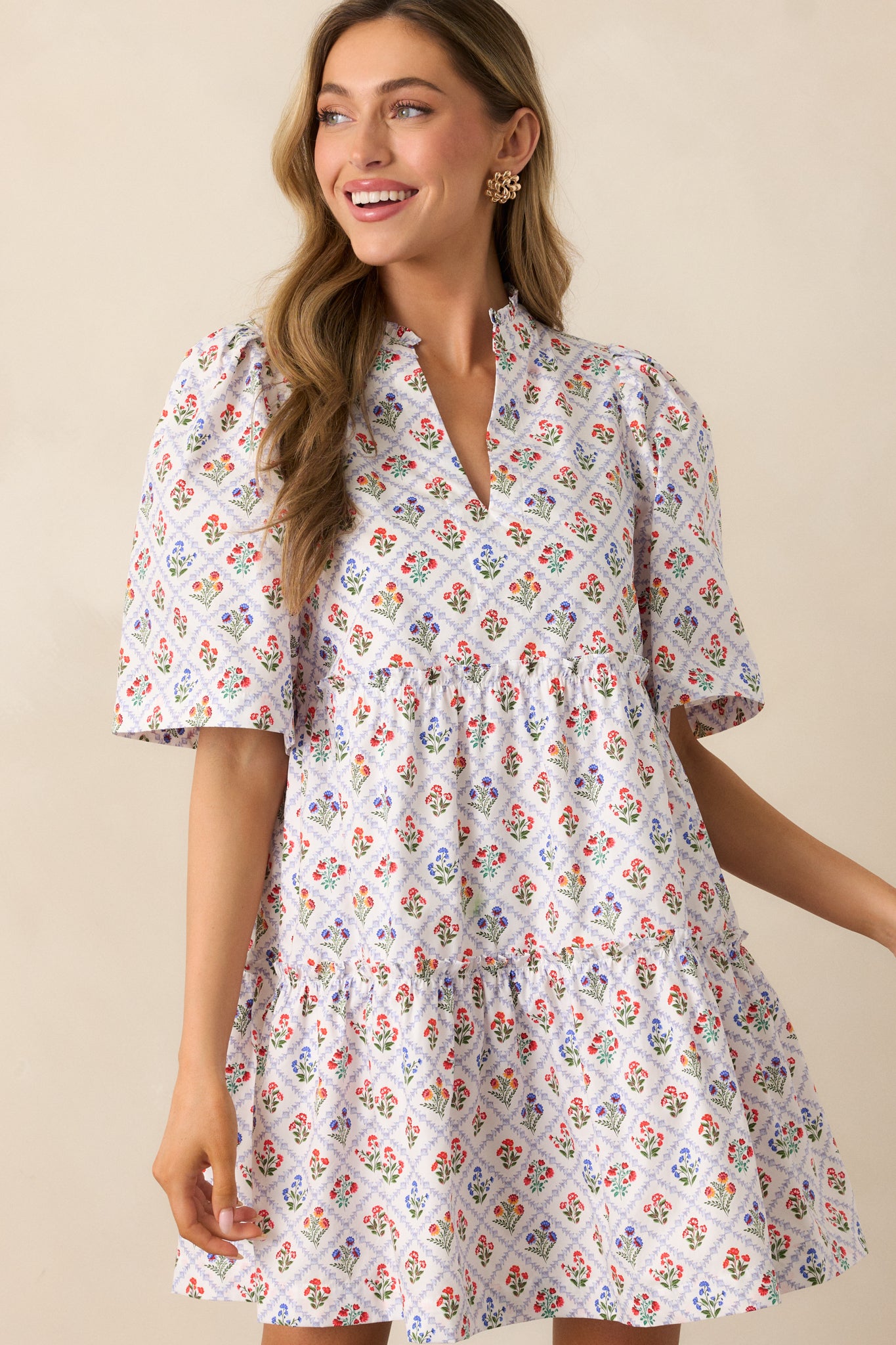 A detailed view of the multicolor floral motifs within the criss-cross grid print, adding a vibrant pop of color to the light blue mini dress.