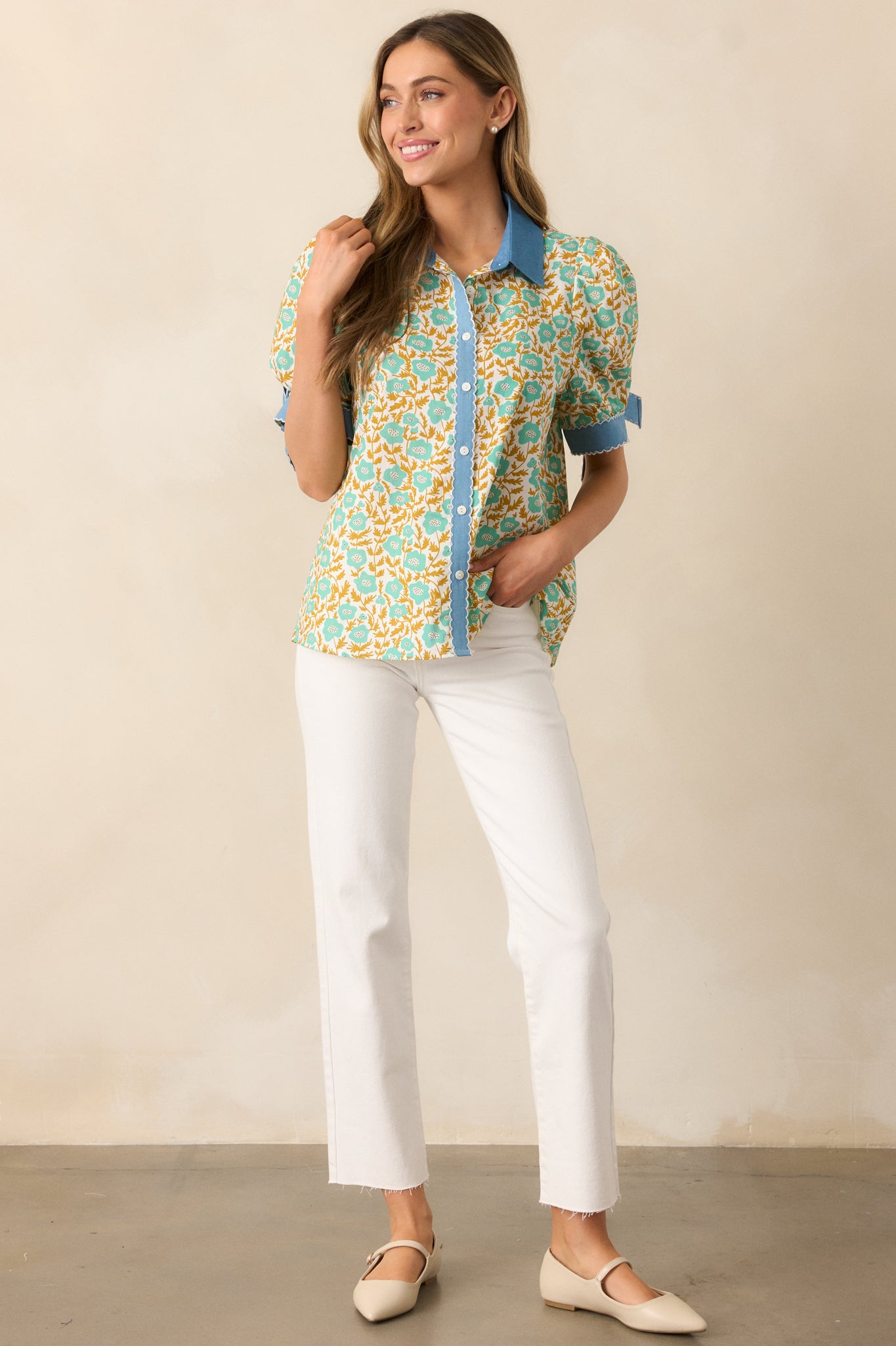 This green floral top blends vintage-inspired embroidery with denim trim accents and delicate bow-tied sleeves.