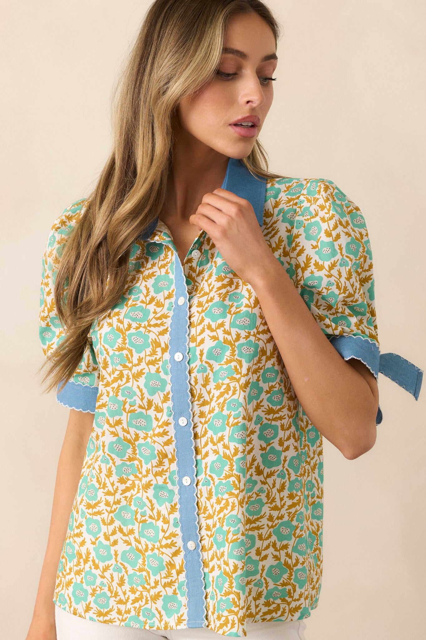 The blue denim trim outlines the design, adding contrast to the delicate floral pattern.