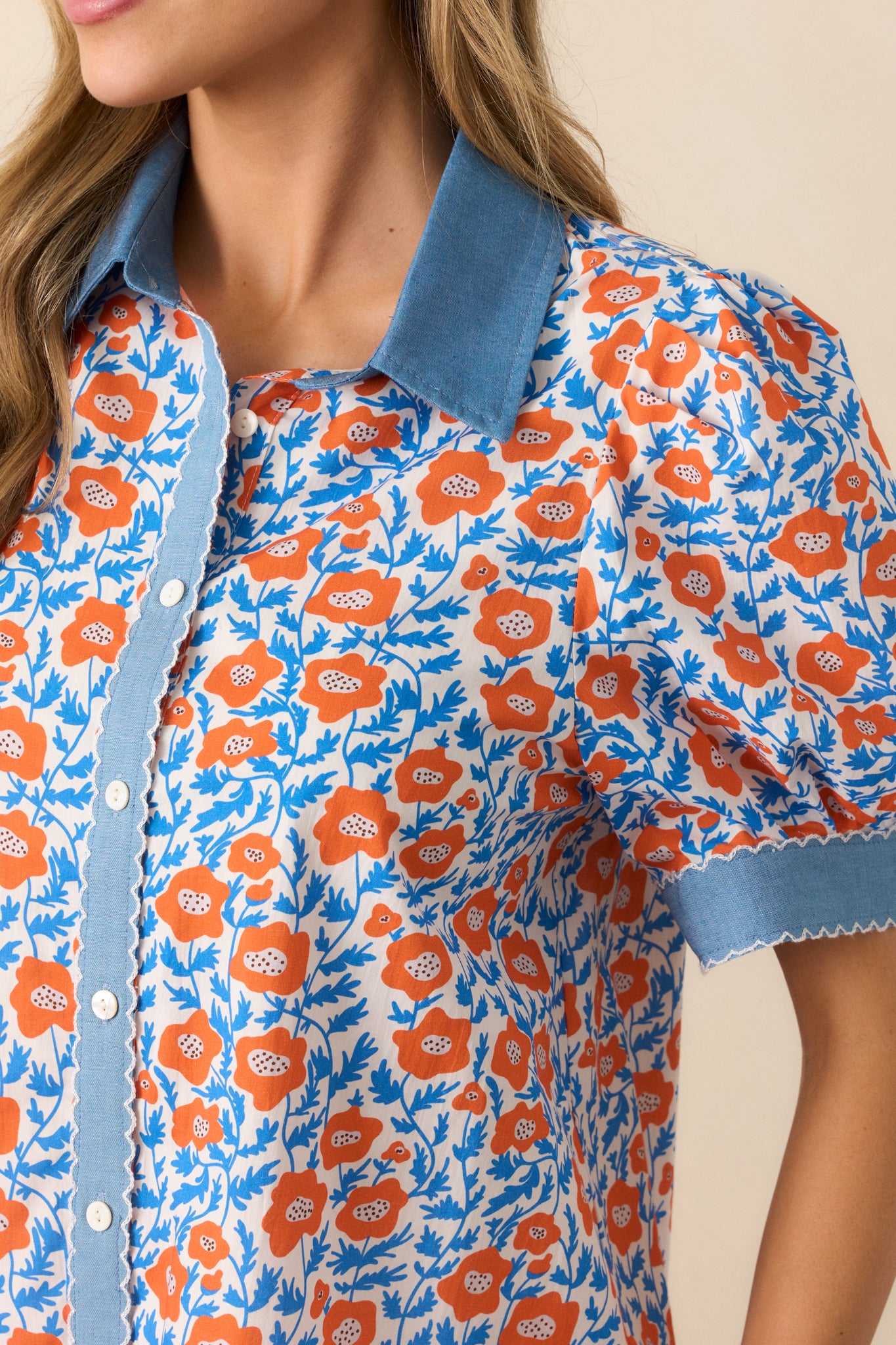 A magnified look at the floral print and denim trim, emphasizing the texture and color contrast in the fabric.