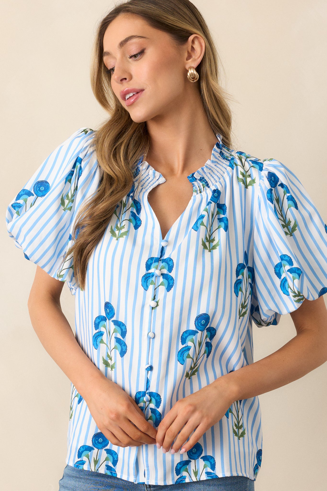 Cropped view of the neckline showing the ruffled edge and beginning of the button front closure.