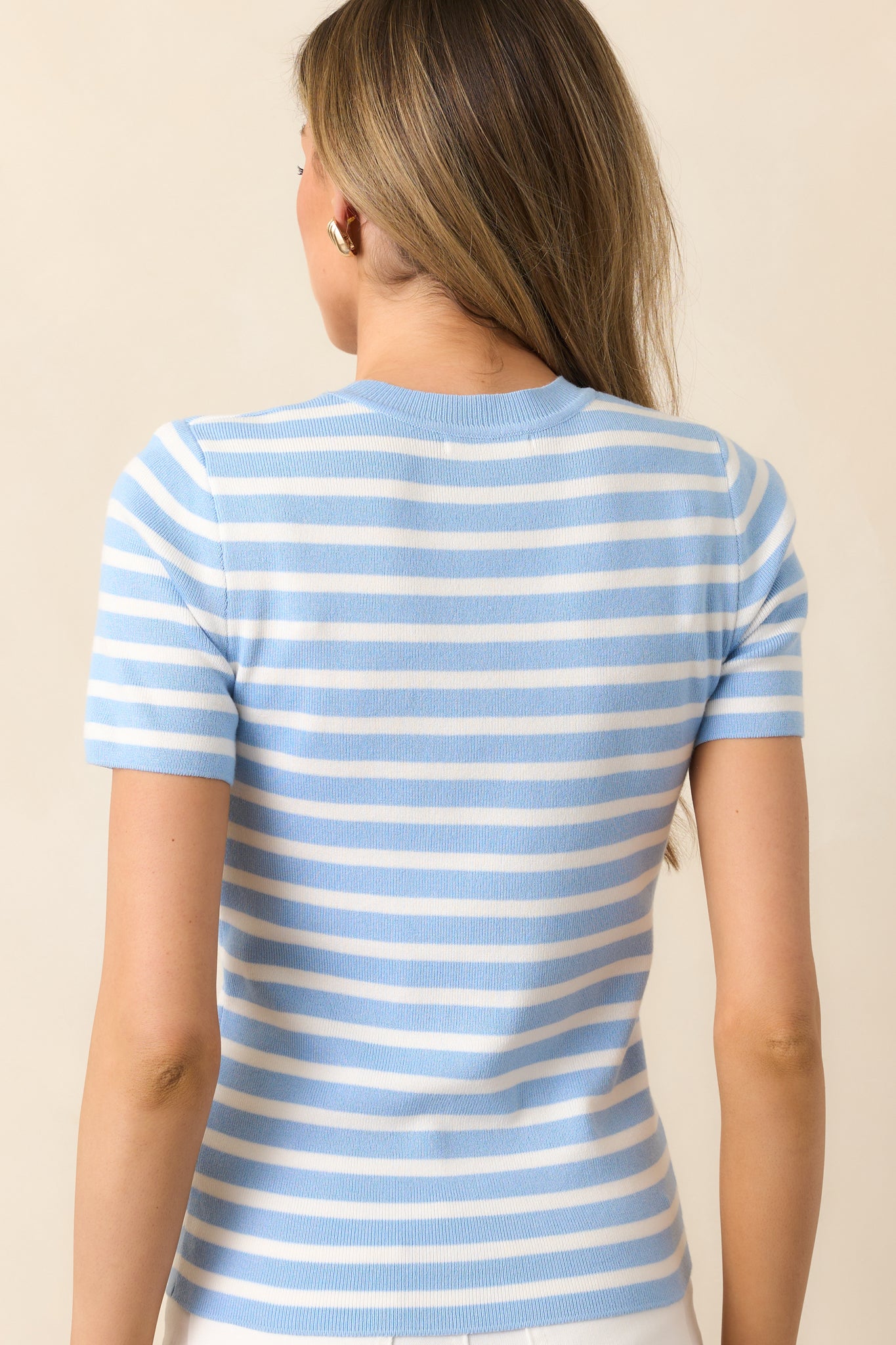 The back of this blue top continues the stripe design seamlessly, keeping the look cohesive and stylish.