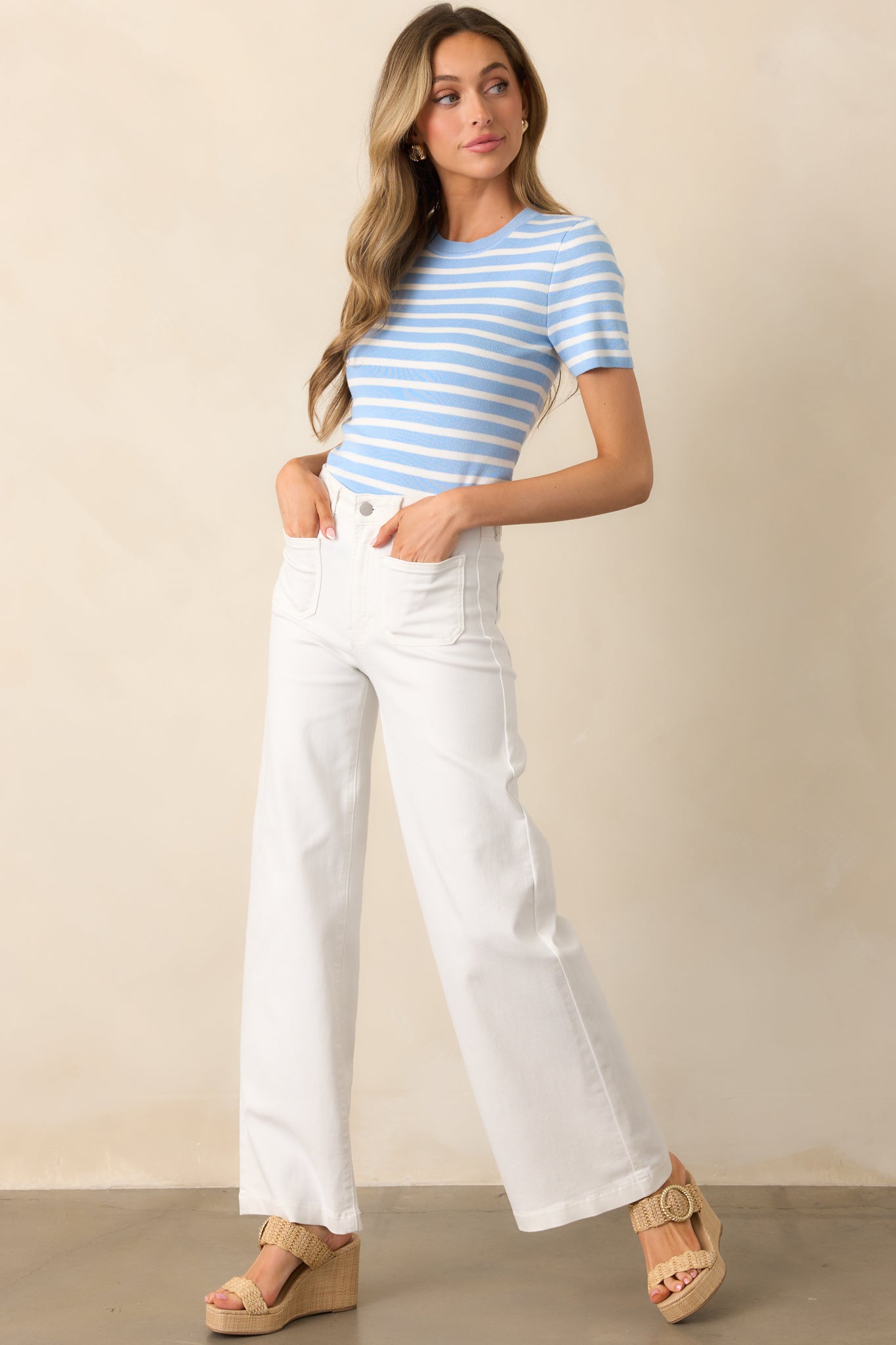 A blue top with a classic round neckline, bold stripe design, and a contrasting solid blue collar