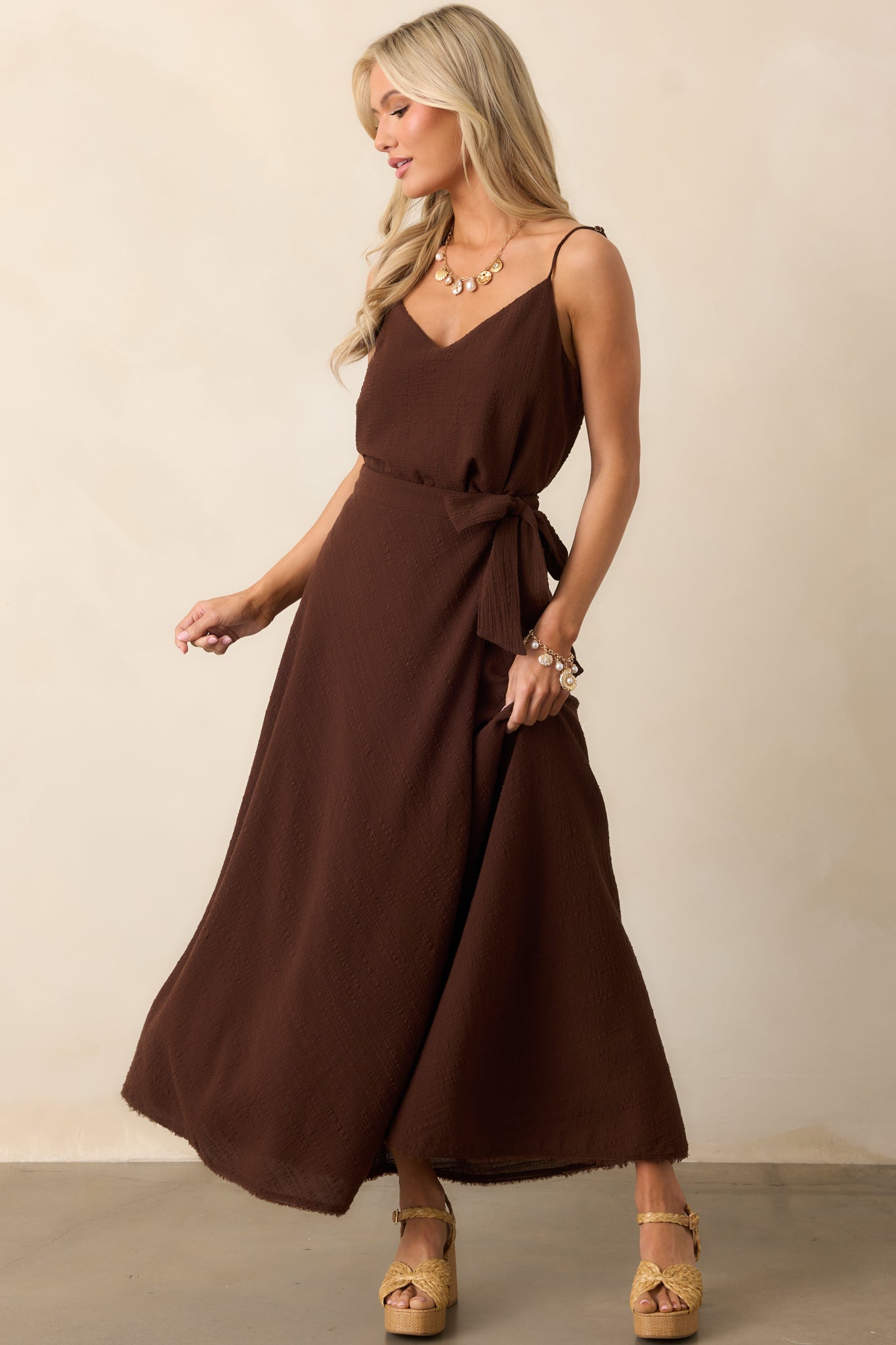 Lightweight brown tank with a relaxed fit and drapey fabric, designed with a v-neckline and cropped length.