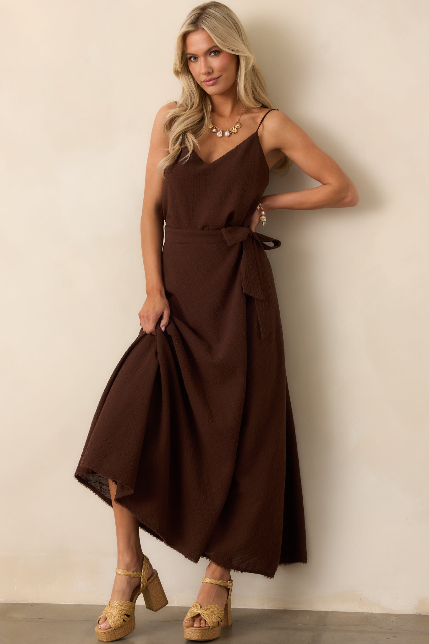 Casual brown tank featuring adjustable thin straps, v-neck cut, and a loose, cropped silhouette.