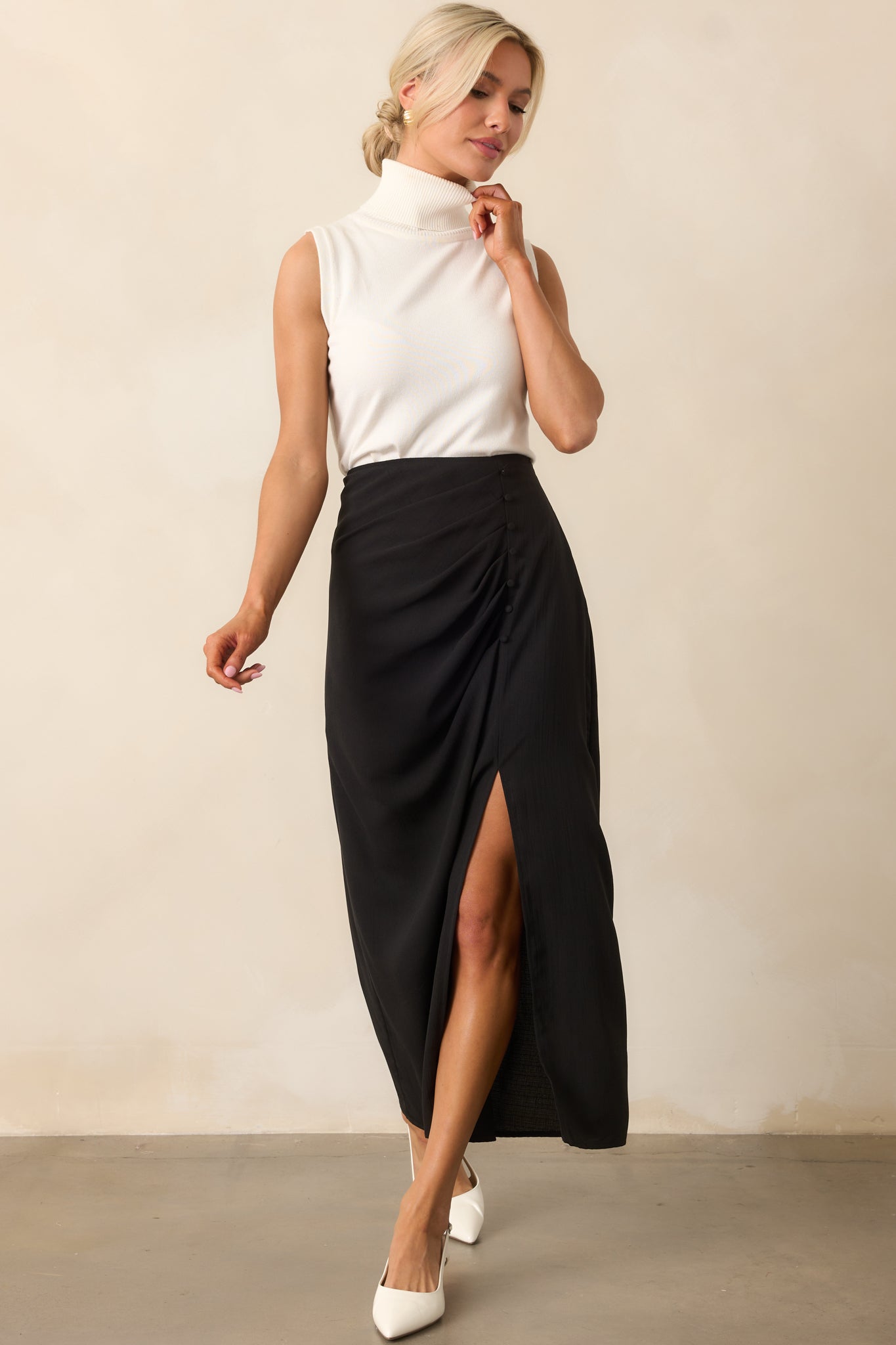 A full body shot emphasizing the structured fit through the waist and hip, and the subtle opening of the side slit.