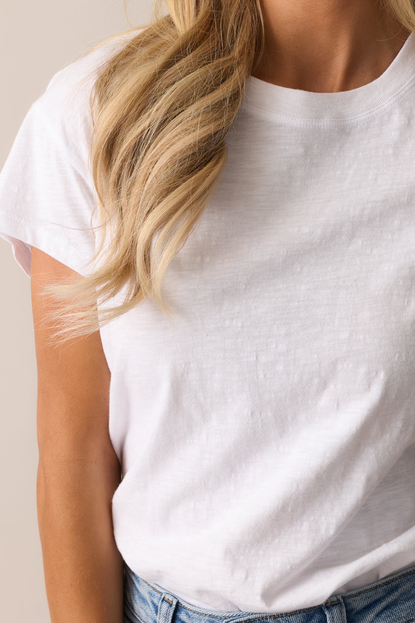 An extreme close-up of the fabric texture, showing the soft material and subtle stitching details.