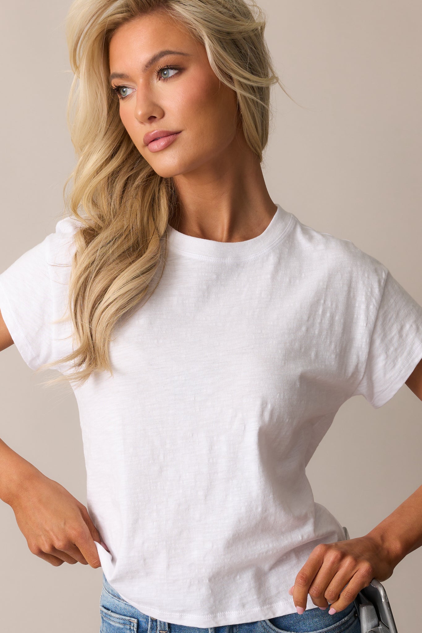 The relaxed-fit white tee featuring a simple design with breathable jersey material and neatly finished short sleeves.