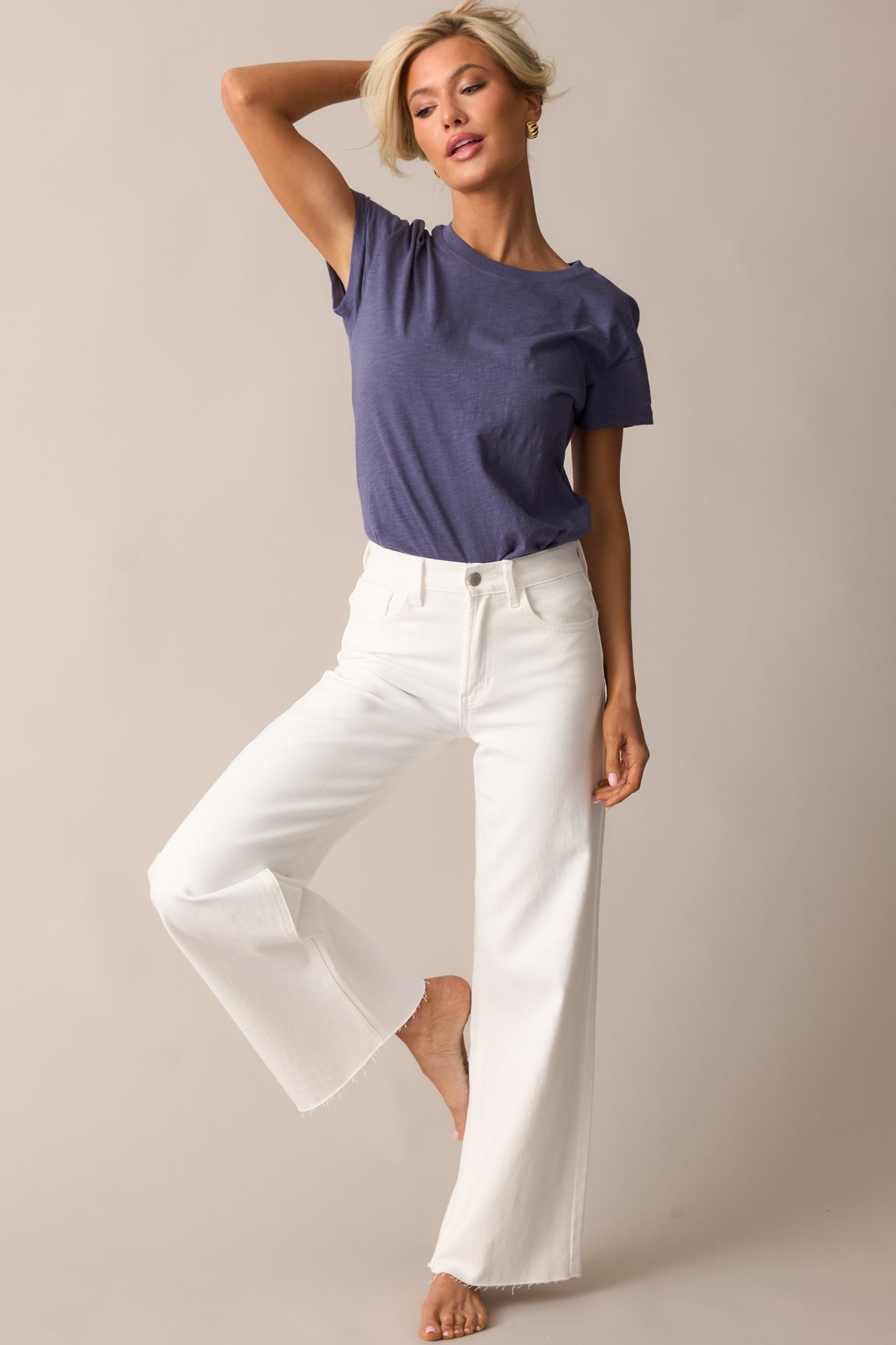 A casual blue tee with a slightly cropped cut, short sleeves, and a relaxed drape for effortless styling.