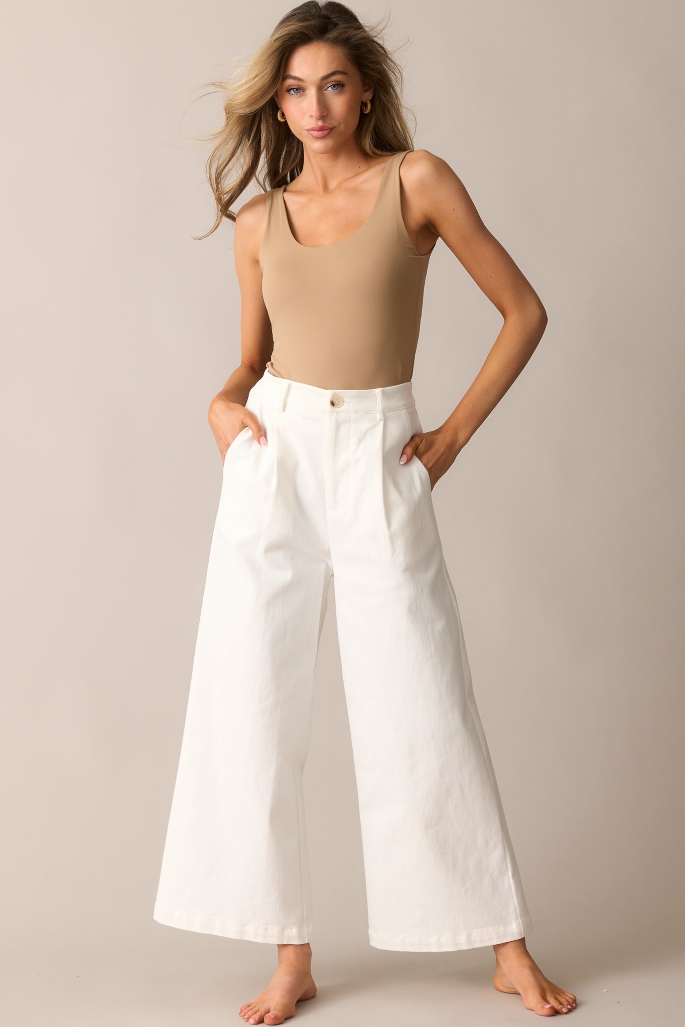 Wide-leg jeans with a button and zipper closure, hip pockets, and a relaxed fit for a timeless look.