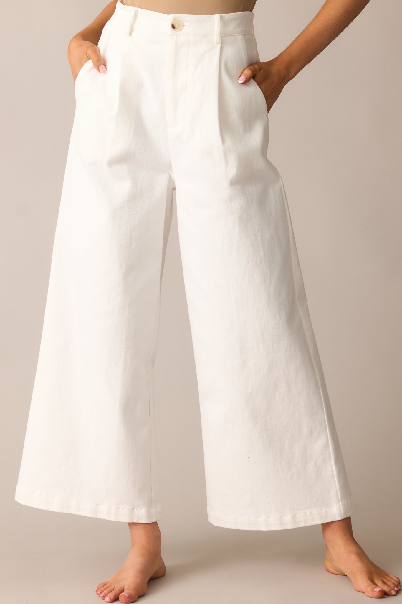 A close-up of the waistband, highlighting the elastic waist insert, button, and zipper closure.