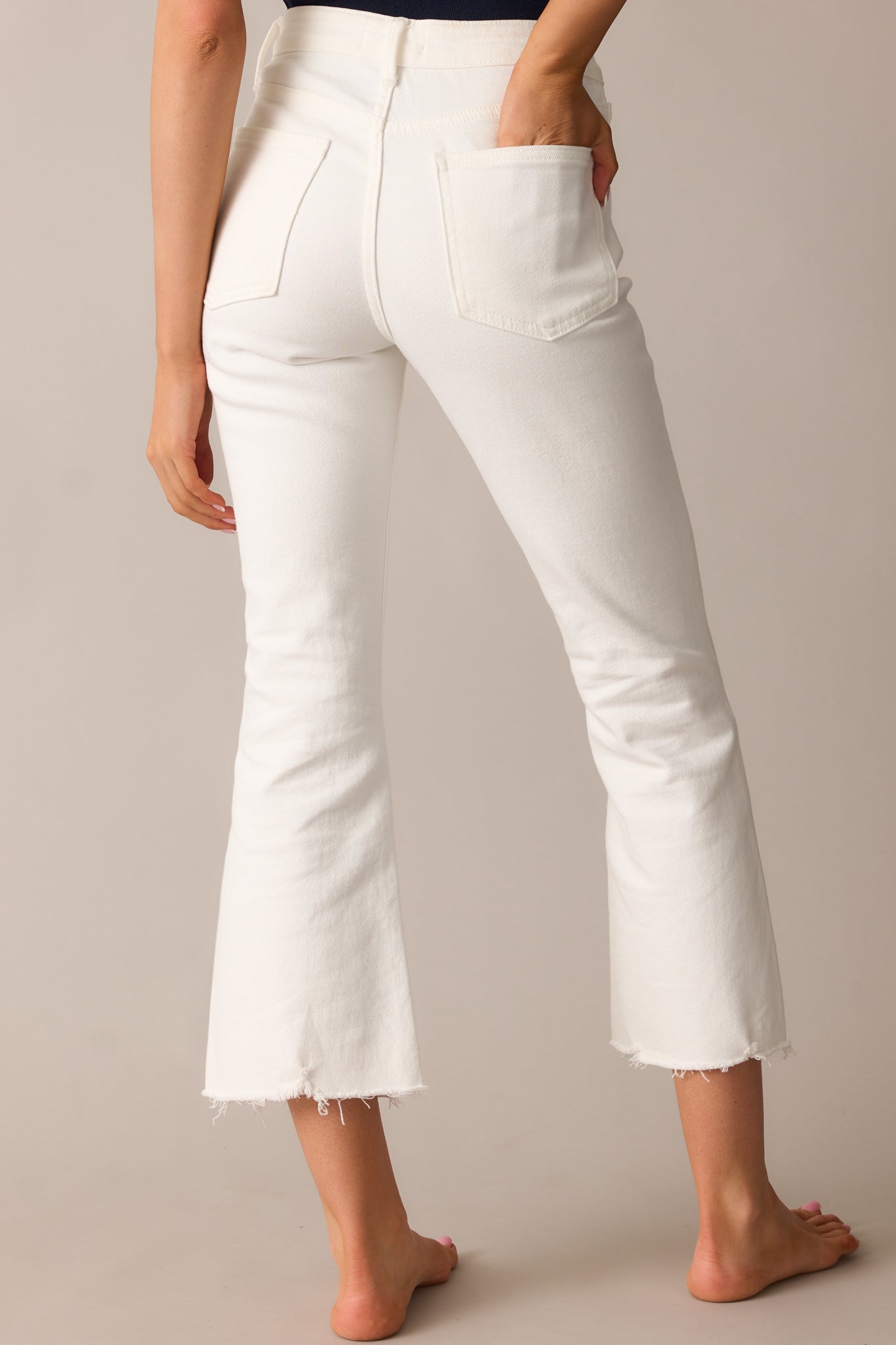 Rear view of the jeans showcasing the functional back pockets and high waisted fit.