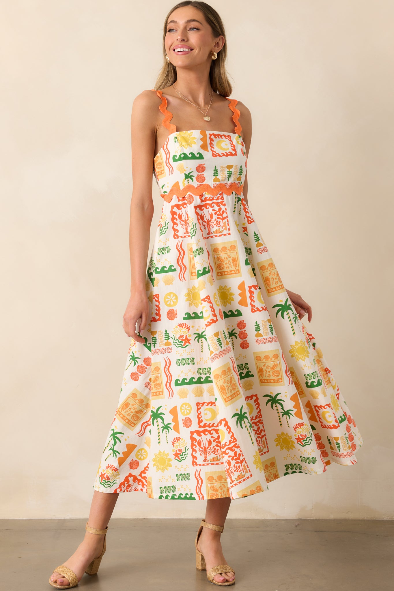 A vibrant maxi dress with a multicolor tropical print, featuring a square neckline, ric rac straps, and a flowing silhouette.