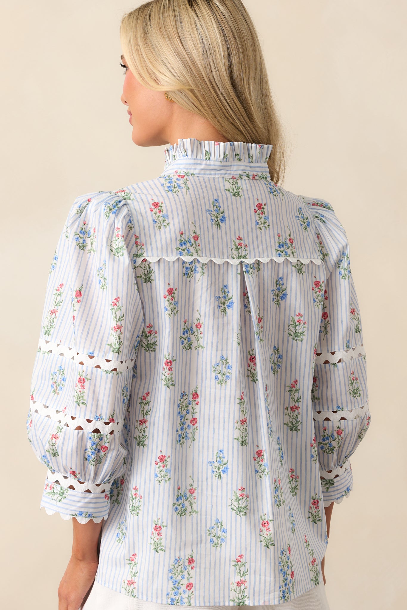 A view from behind of the top, showing continued stripe print, relaxed fit, and puff sleeve shape.