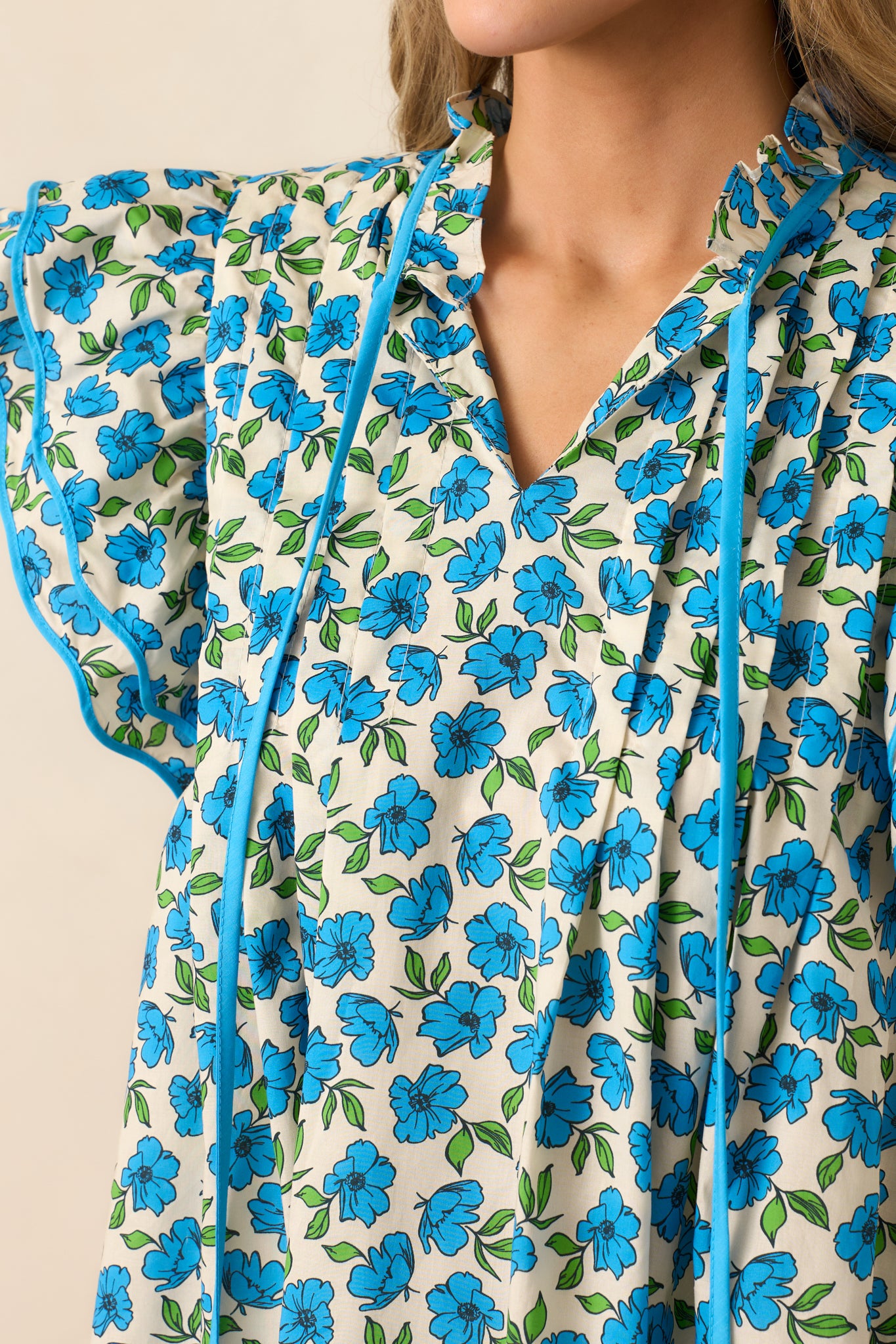 Zoomed-in on the self-tie detailing at the neckline, showing the delicate ties and how they add a charming touch to the top.