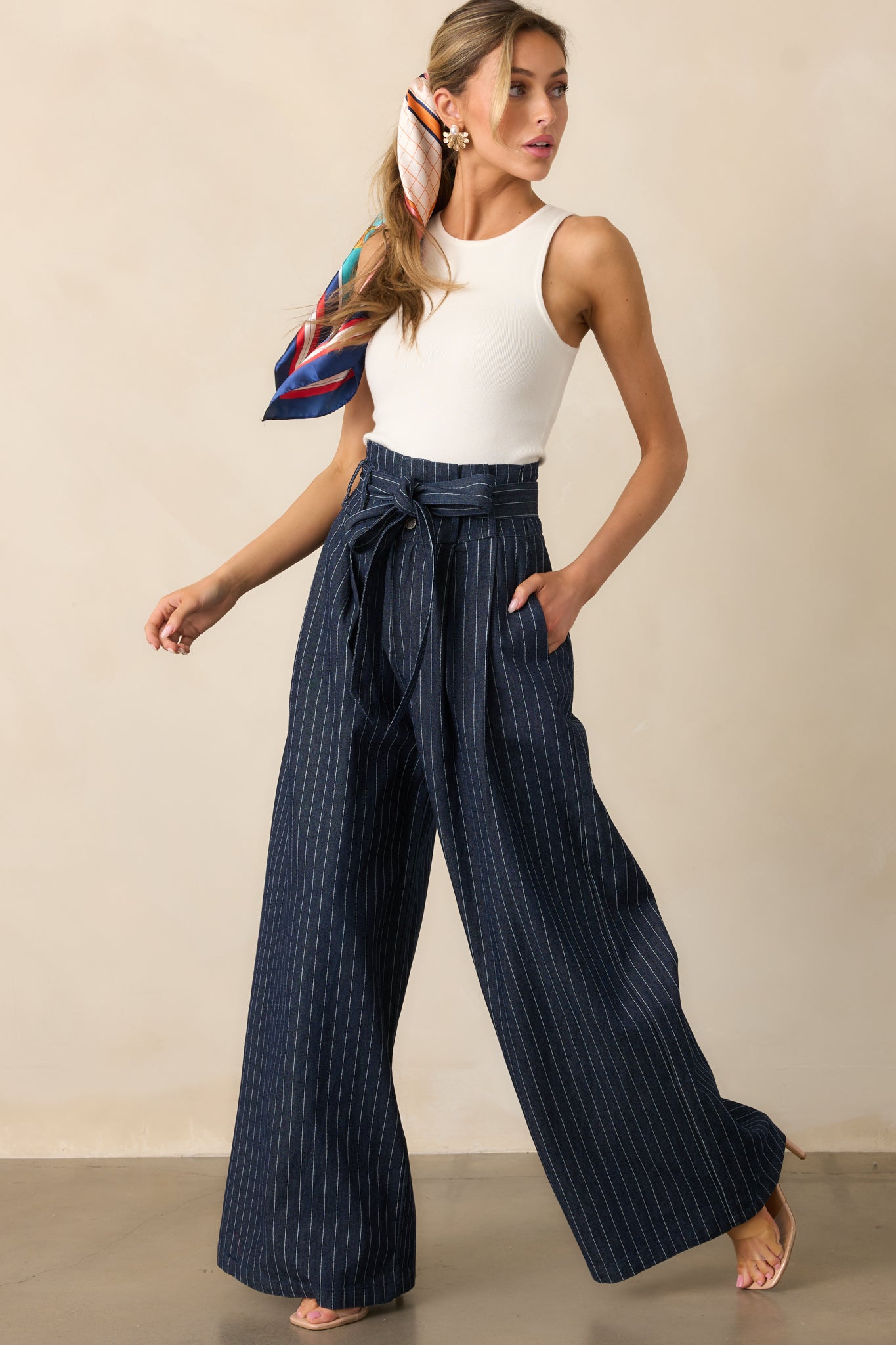A full-length shot of the high-waisted jeans with a wide-leg silhouette, highlighting the classic stripes and structured design.