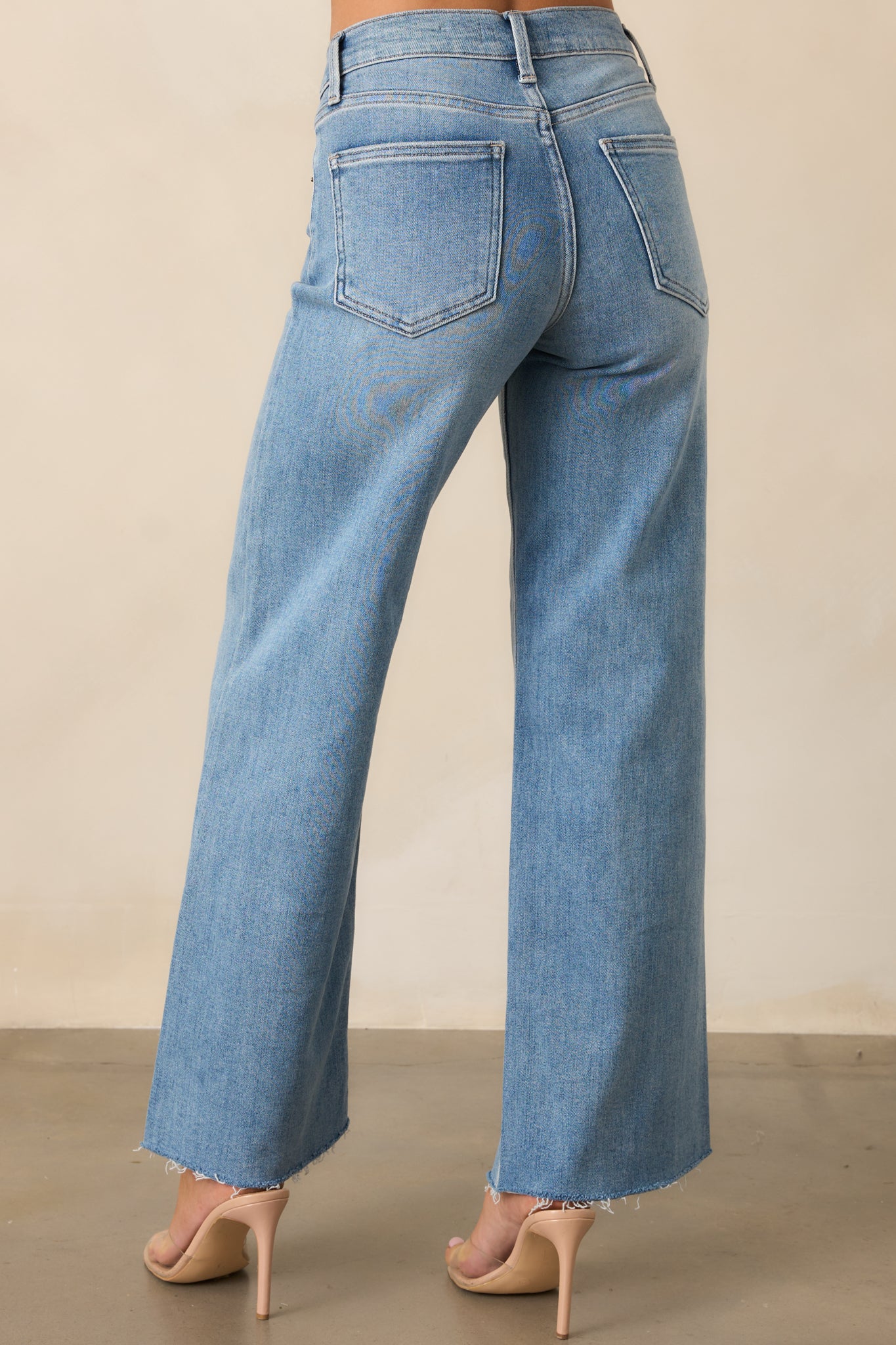 A back view of the jeans, highlighting the functional back pockets and wide straight-leg fit for a timeless denim look.