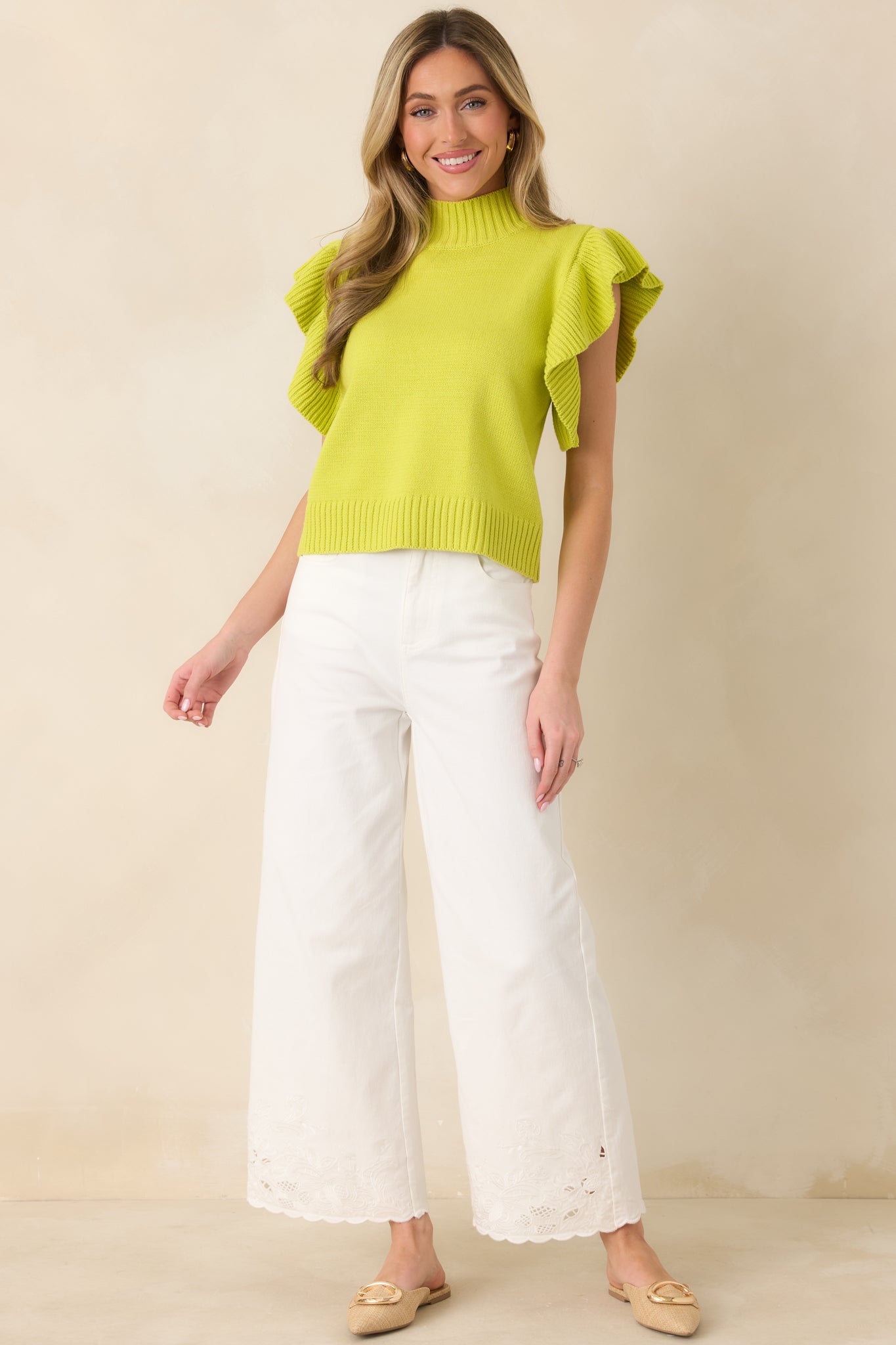 Textured yellow-green knit top with medium-weight fabrication, ribbed neckline and hem, and flutter sleeve details for dimension and shape.