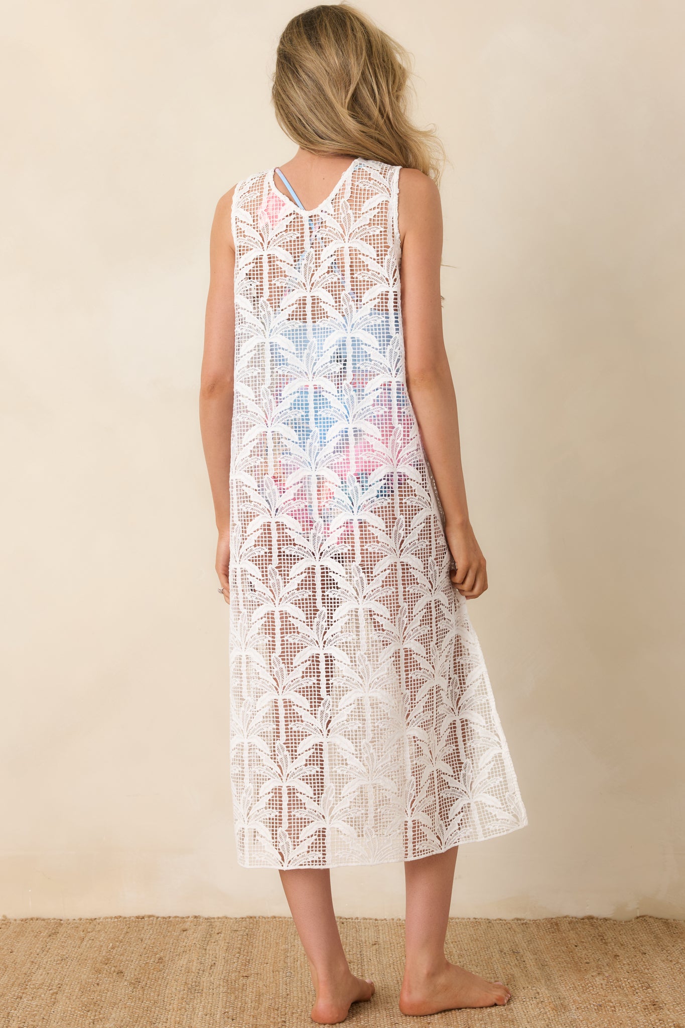 Back view of ivory sheer lace midi cover-up dress with a sleeveless design and flowing silhouette.
