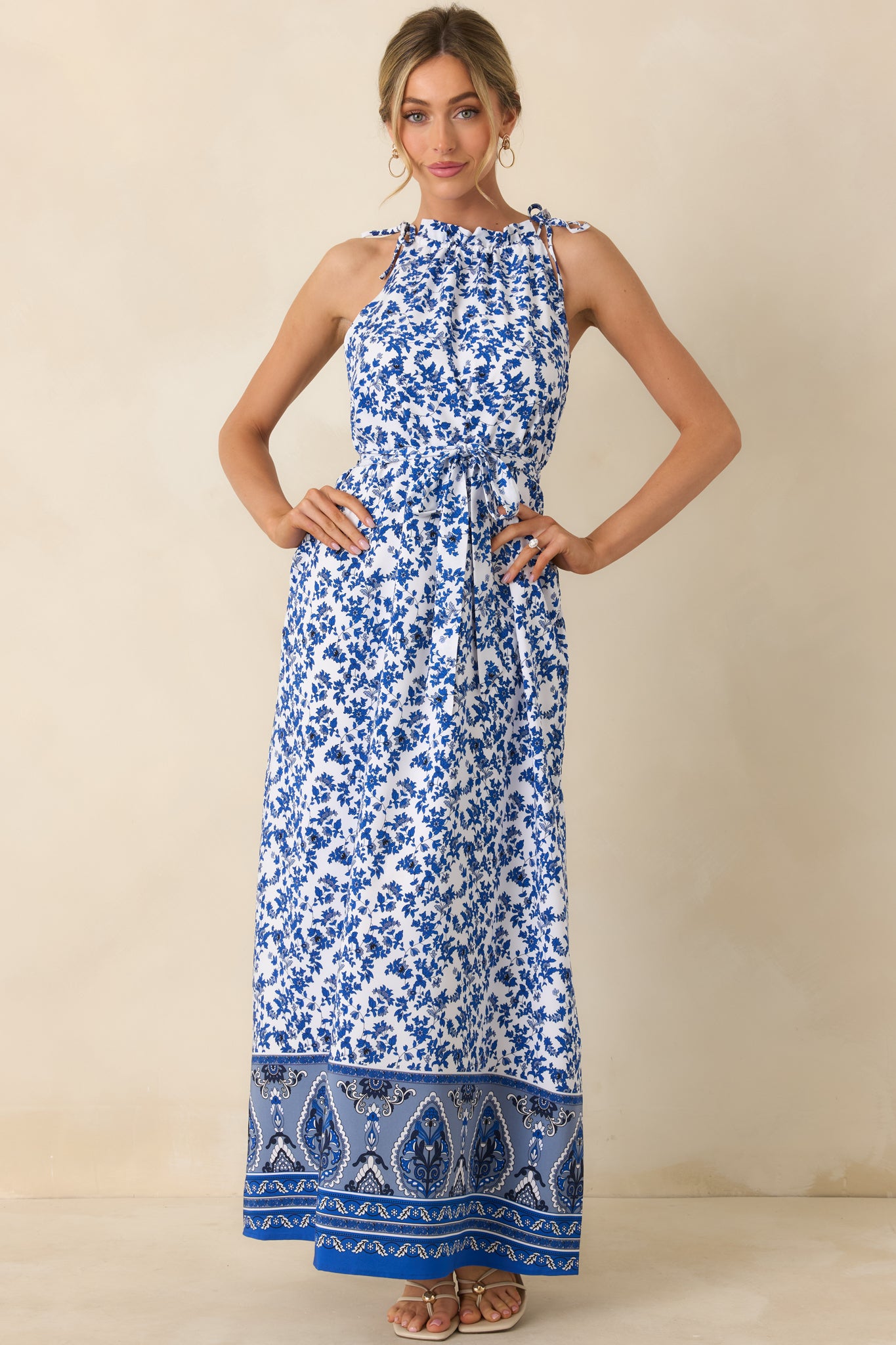 Blue dress showcasing ruffled collared neckline, adjustable straps, and self-tie waist belt.