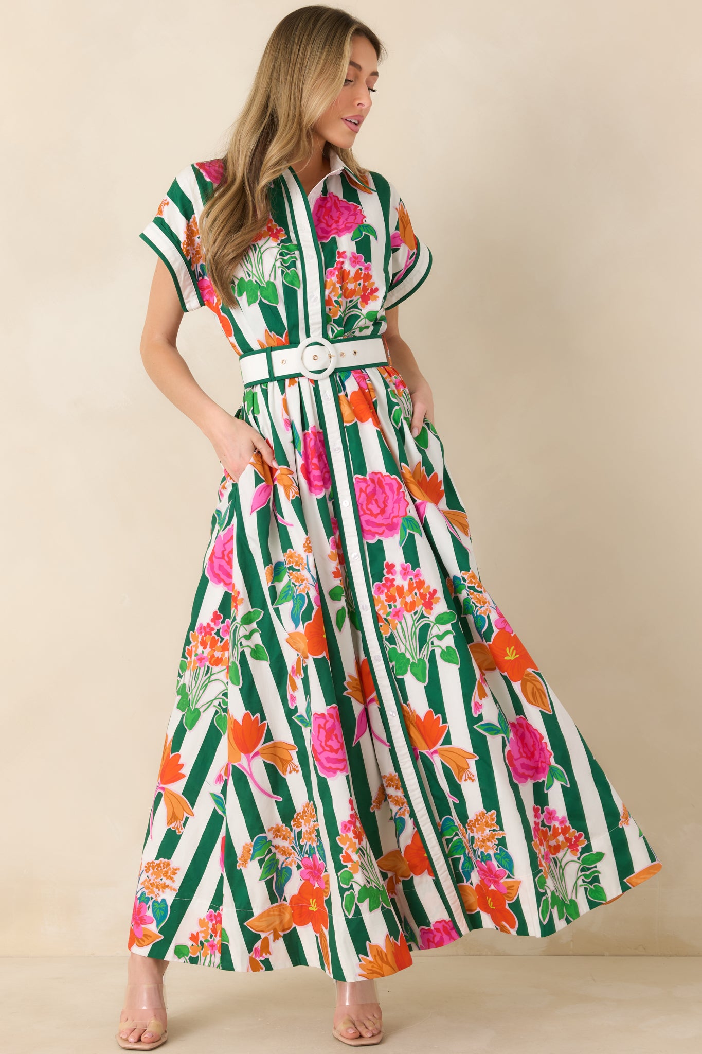 Green striped floral maxi dress with a structured collar, button-front design, and belted waist creating a defined silhouette.