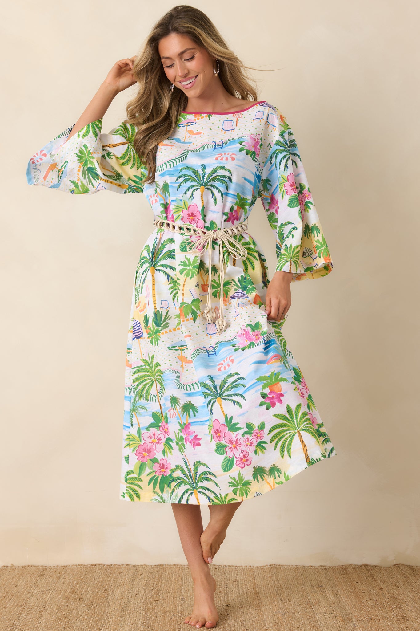 Relaxed caftan dress with boat neckline, pink contrast trim, and flowy 3/4 sleeves.