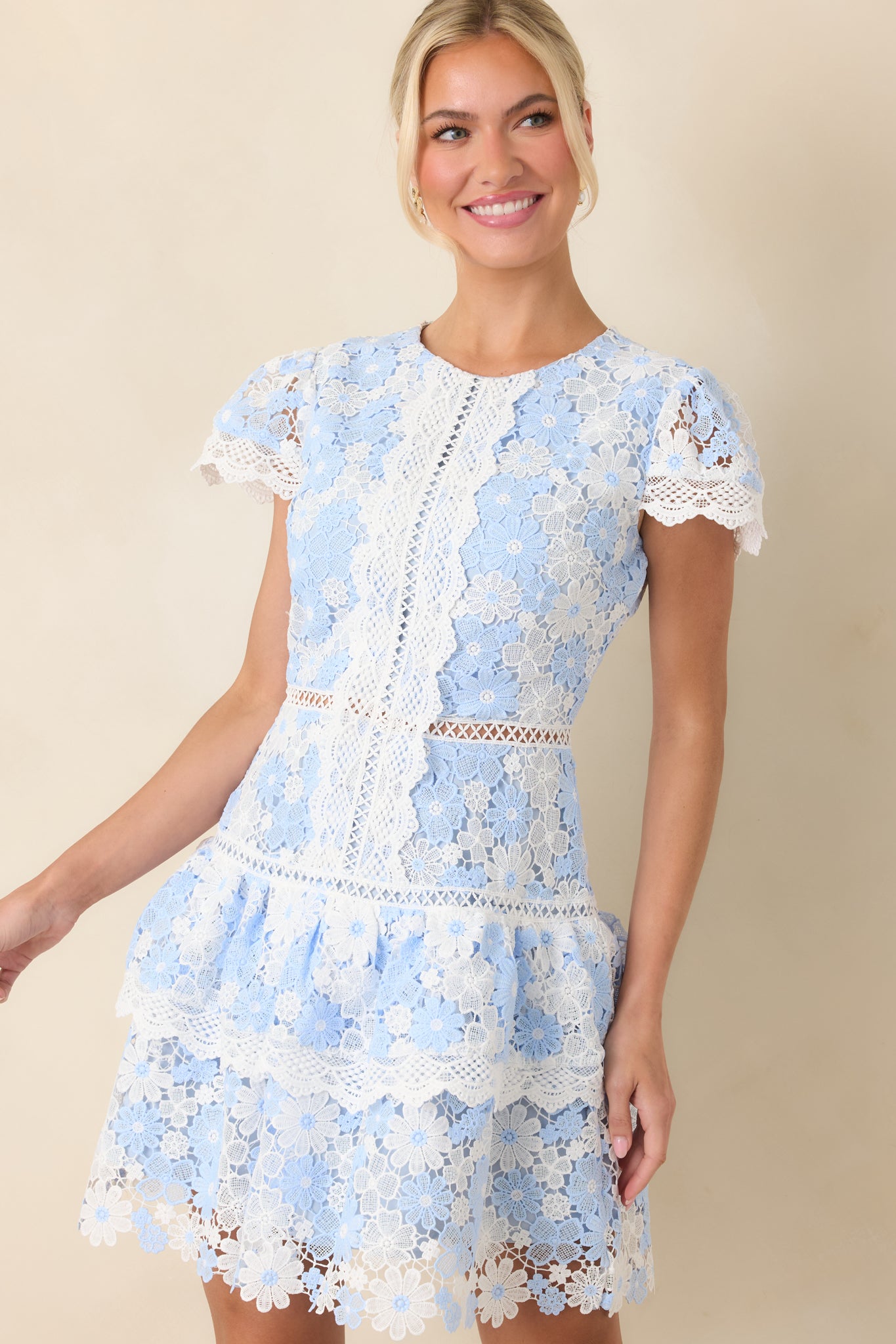Closer look at the intricate blue and ivory lace overlay, highlighting the dimensional floral pattern.