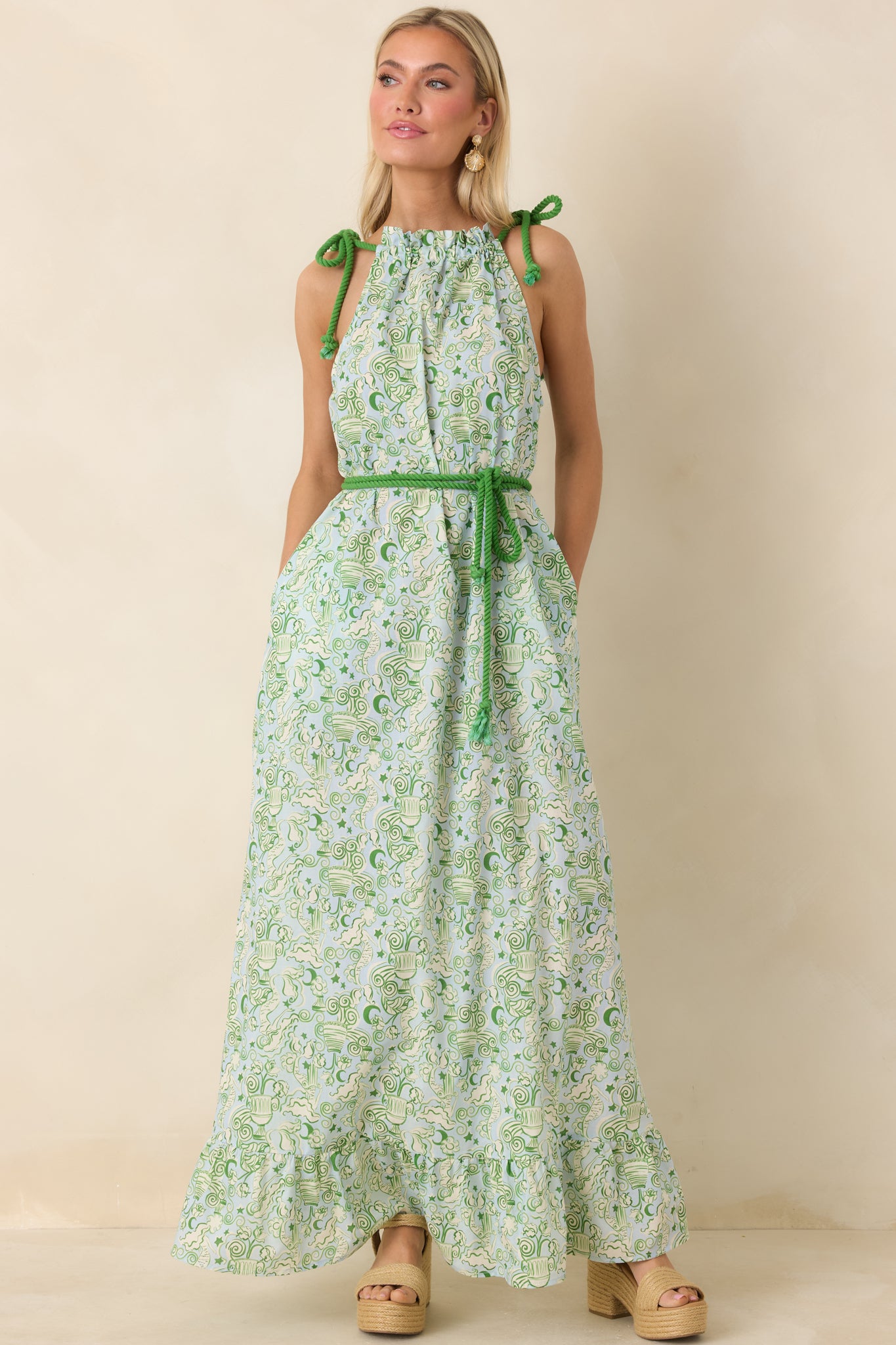 Blue and green cotton maxi dress with adjustable green rope shoulder ties, relaxed bodice, and flowing skirt with ruffled hem.