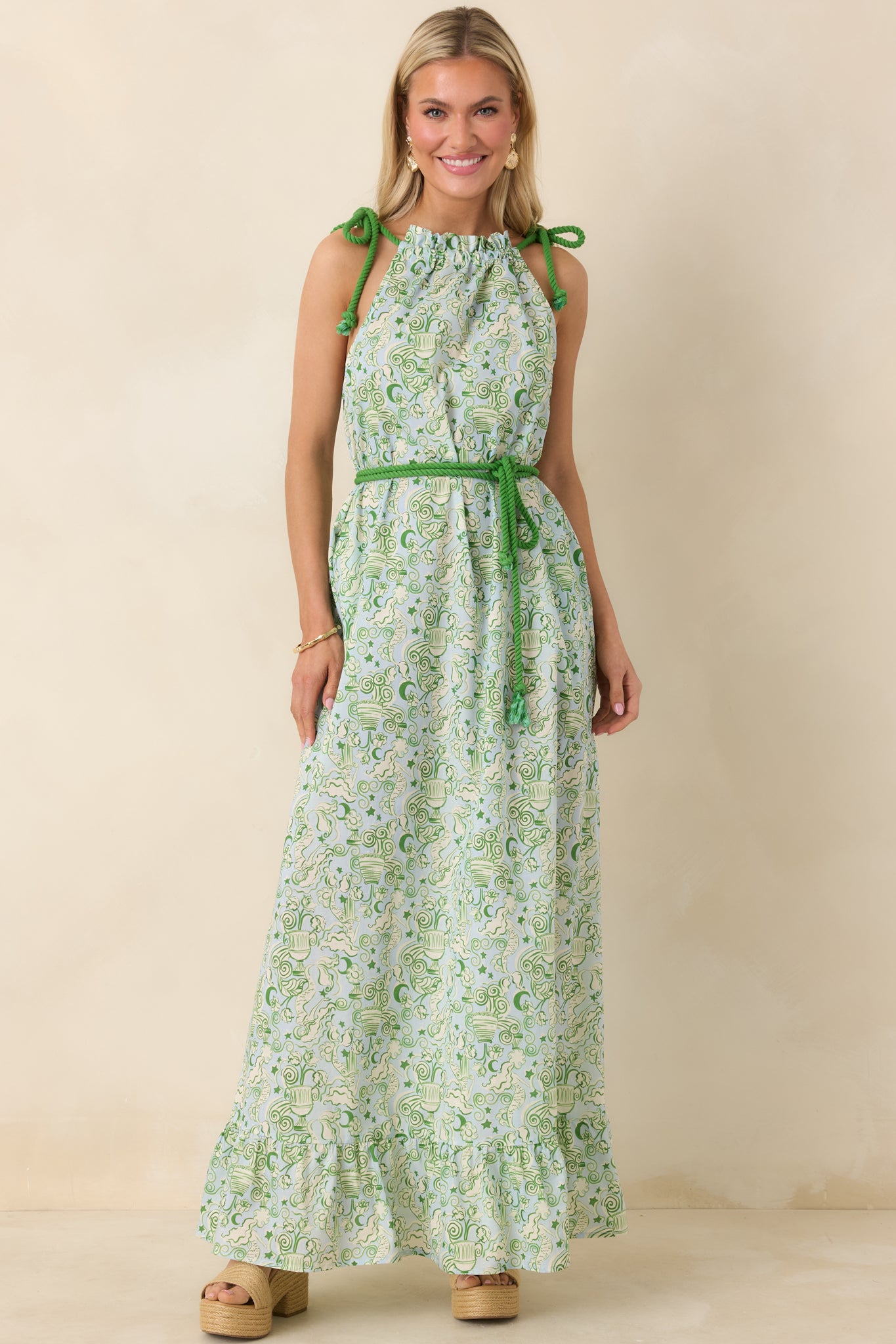 Mermaid-print maxi dress in breathable cotton with adjustable rope straps, cinched waist tie, and sweeping ruffled hemline.