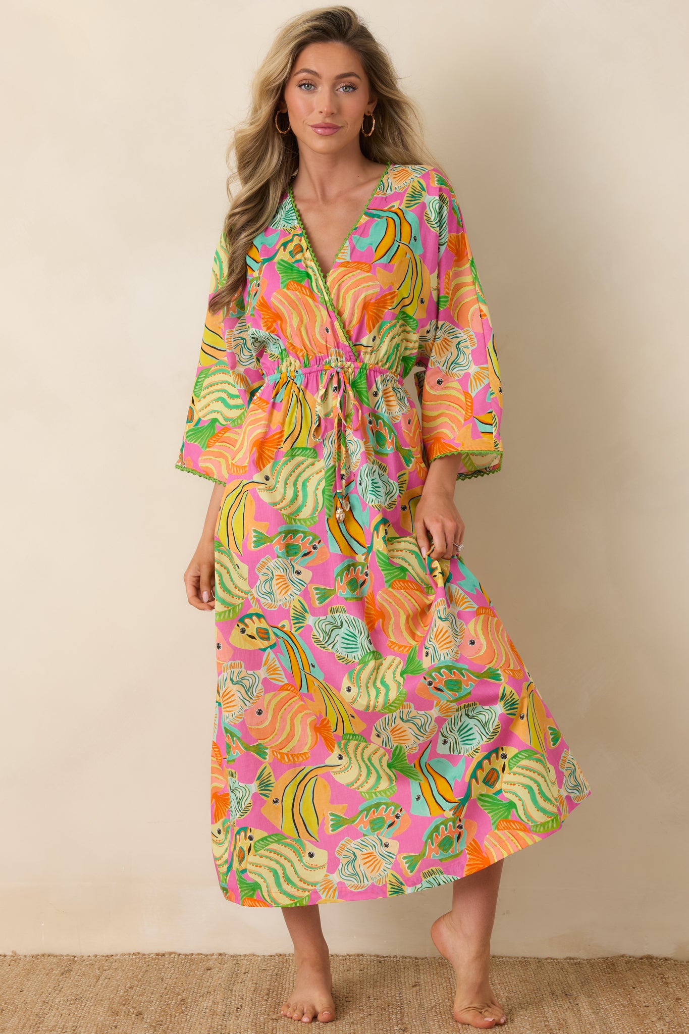 Lightweight cotton dress with V-neckline, billowy elbow-length sleeves, and adjustable drawstring waist.