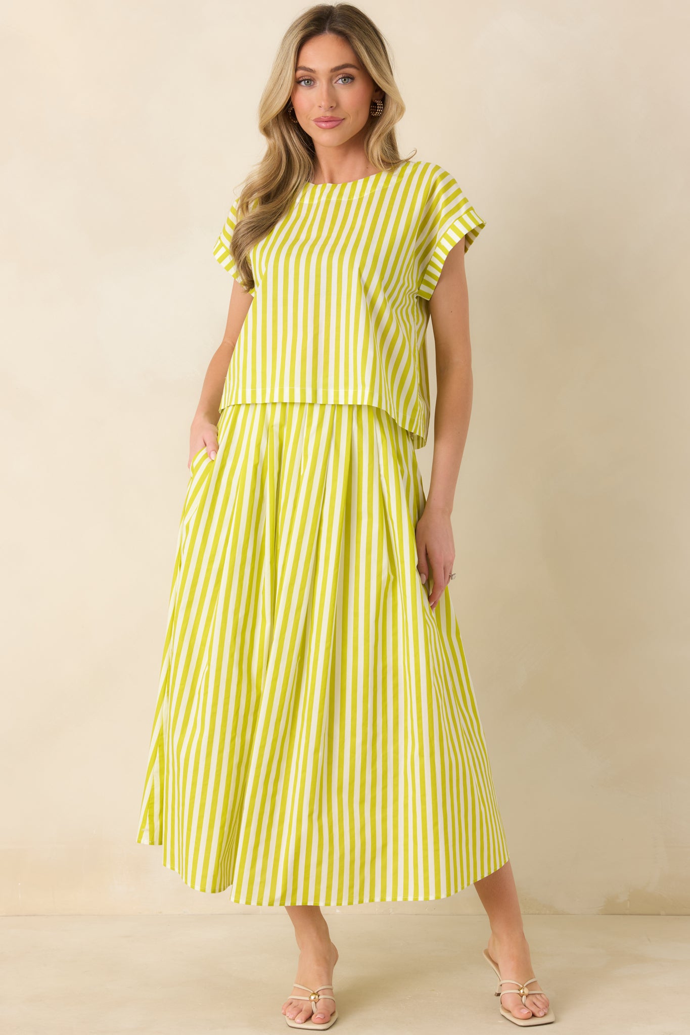 Full-body view of the green striped maxi skirt highlighting its lightweight woven fabric and flowing movement.