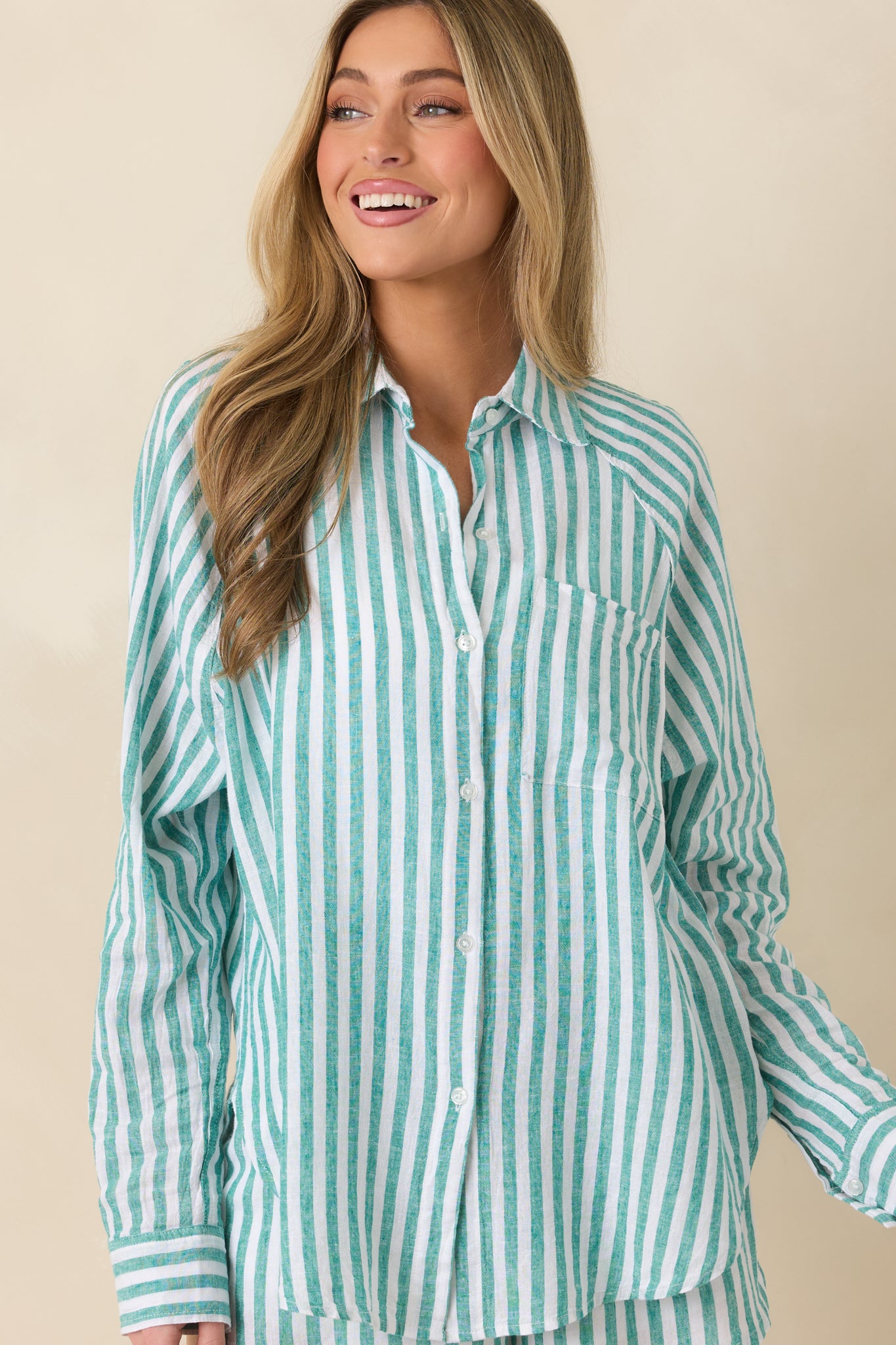 Front cropped image of lightweight striped linen shirt featuring subtle vertical lines and a relaxed drape across the bodice.