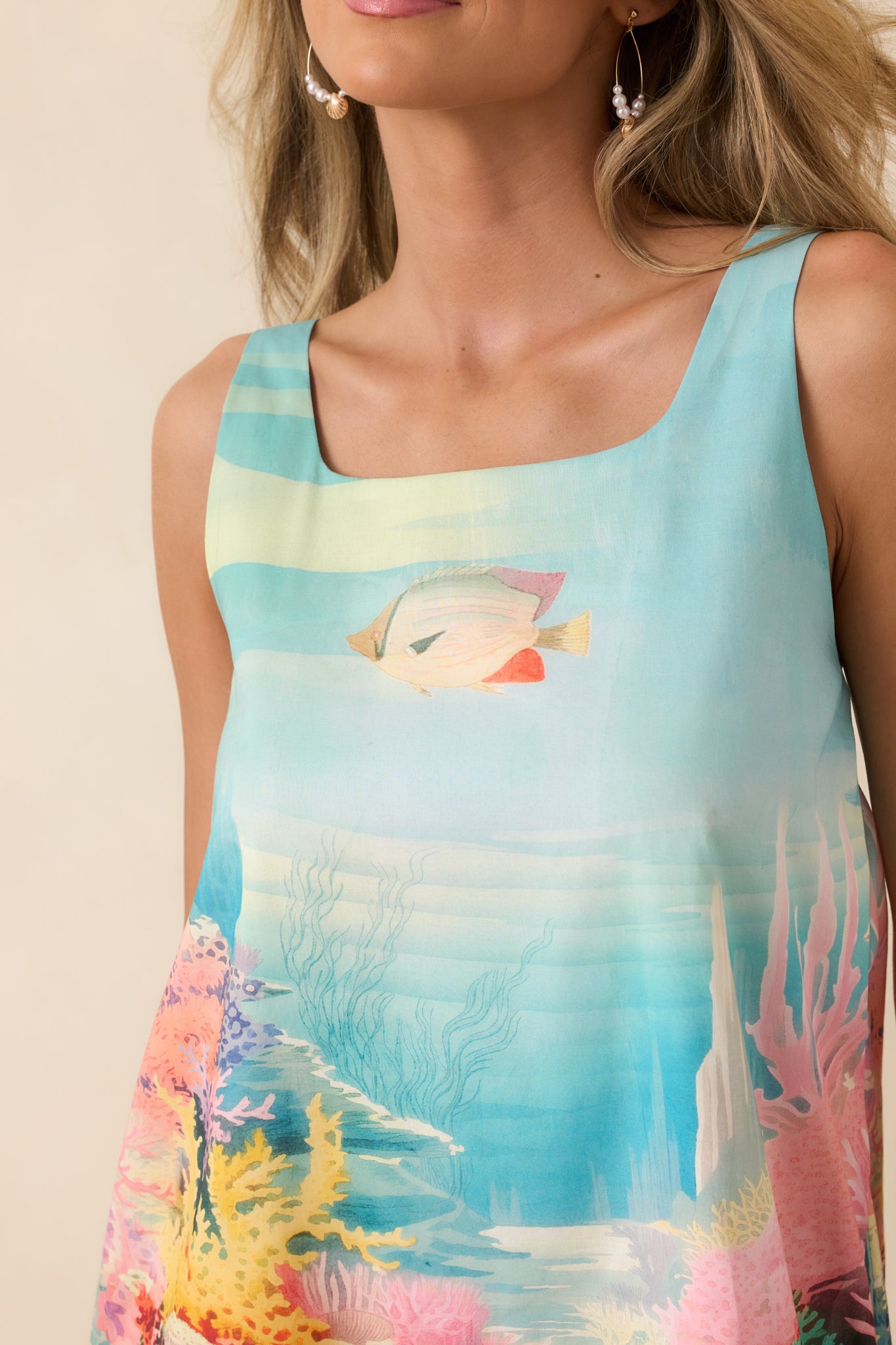 Detailed view of the coral, sea life, and wave motifs on the reef-inspired mini dress.