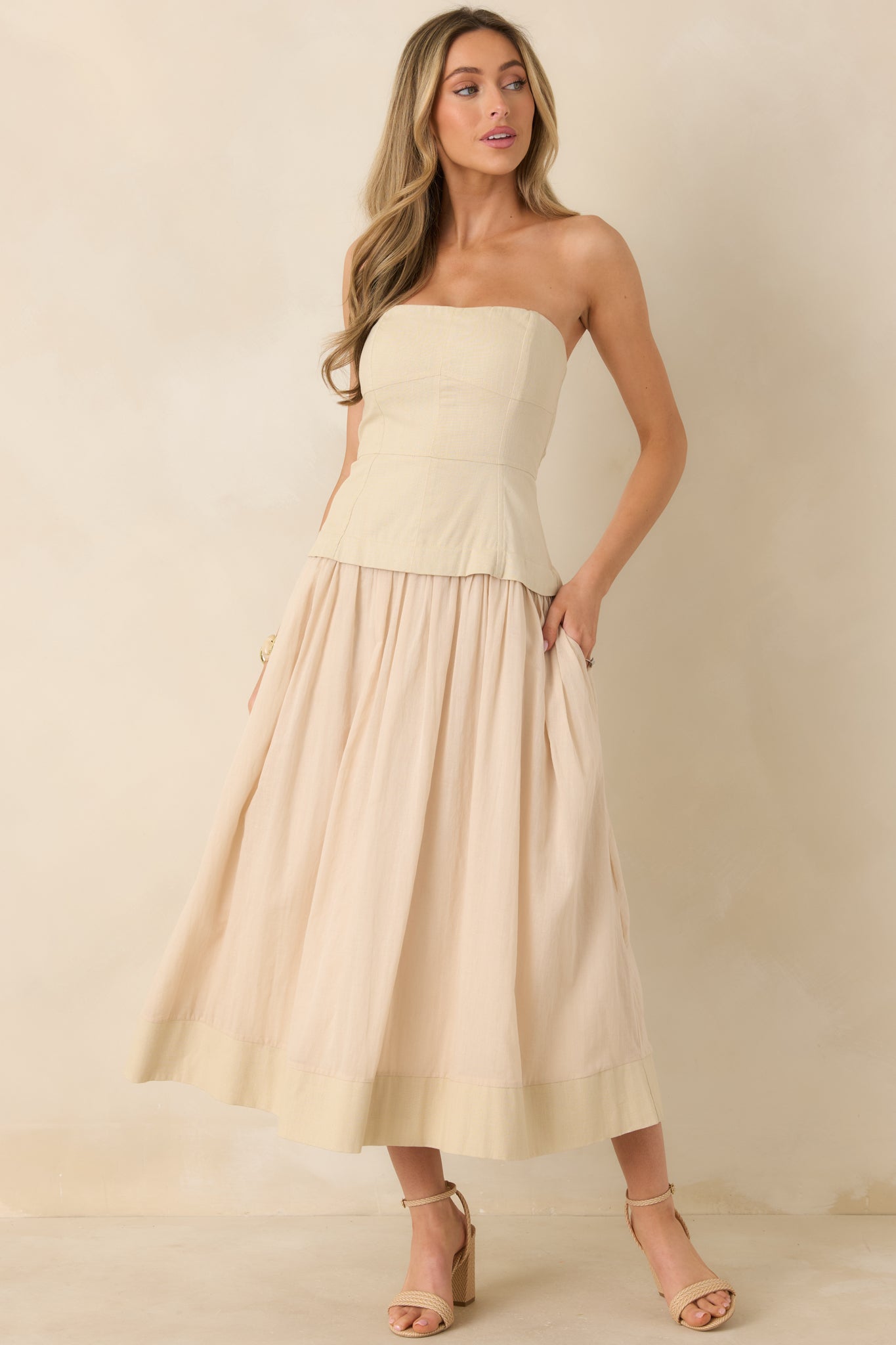 Midi dress with gathered skirt, paneled fitted bodice, and clean spaghetti straps.