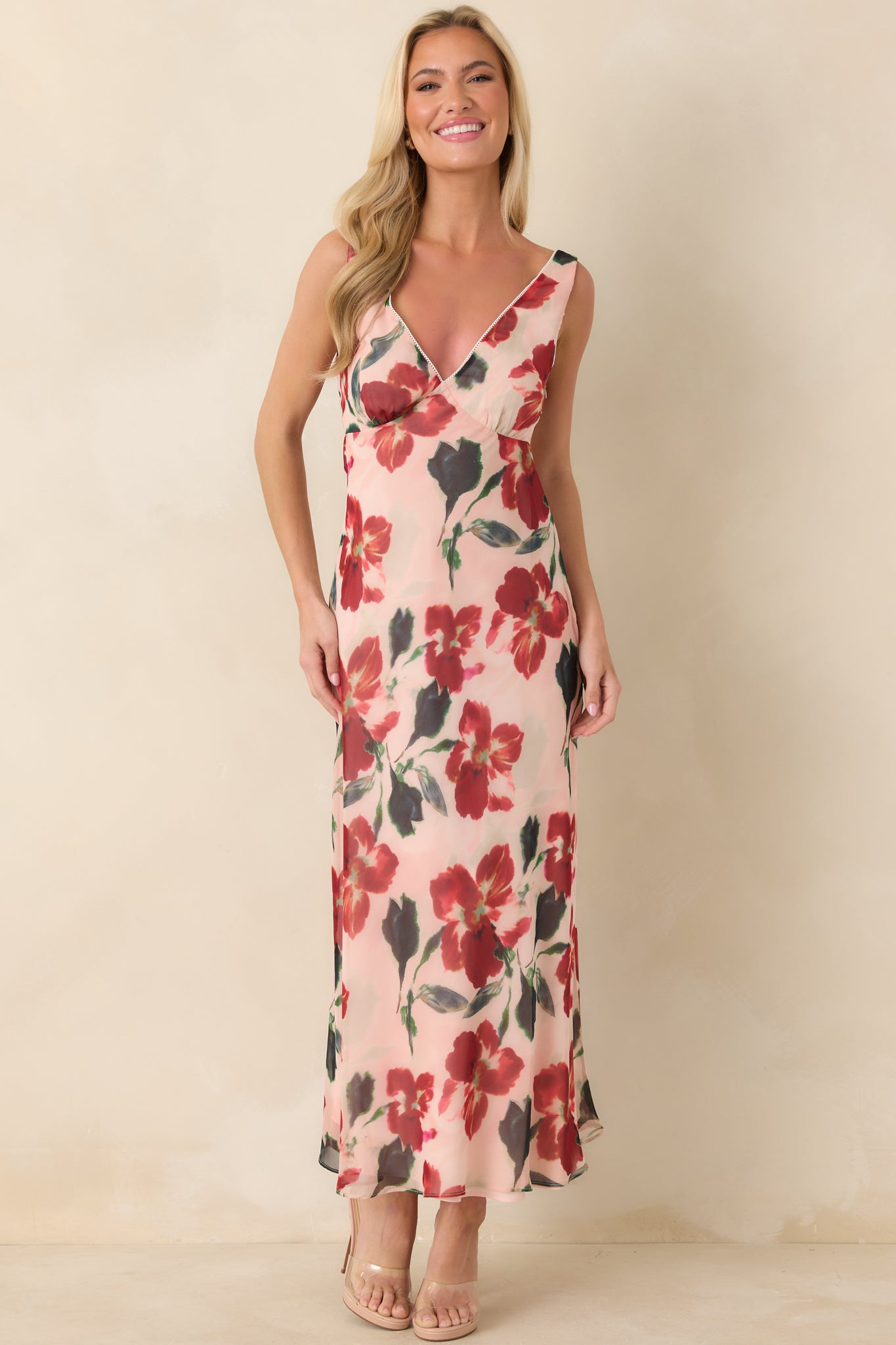 Front-facing angle of red midi dress highlighting sleeveless silhouette and smooth, streamlined fit.